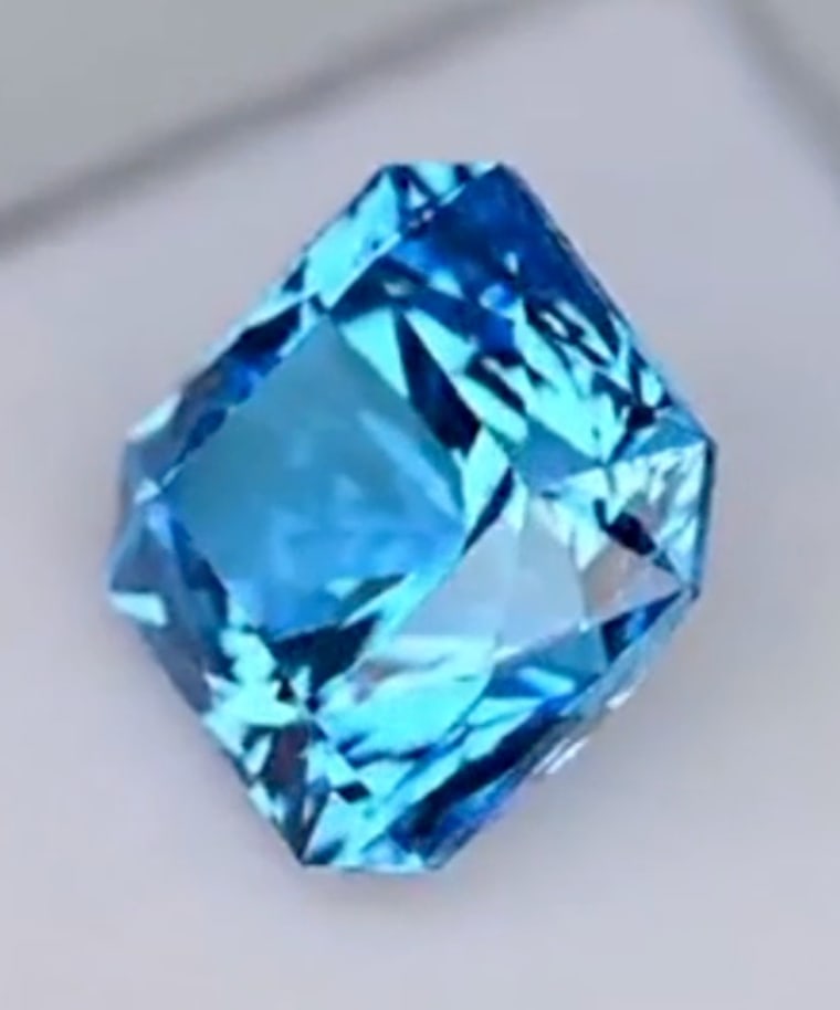 Neon Blue Paraiba Tourmaline Asscher Cut VVS 11.85ct from Brazil: an exceptionally rare, high-value gemstone, characterized by its electric, tropical blue-green hue (the "neon" glow from copper), significant size (11.85 carats), Asscher cut for brilliance, VVS