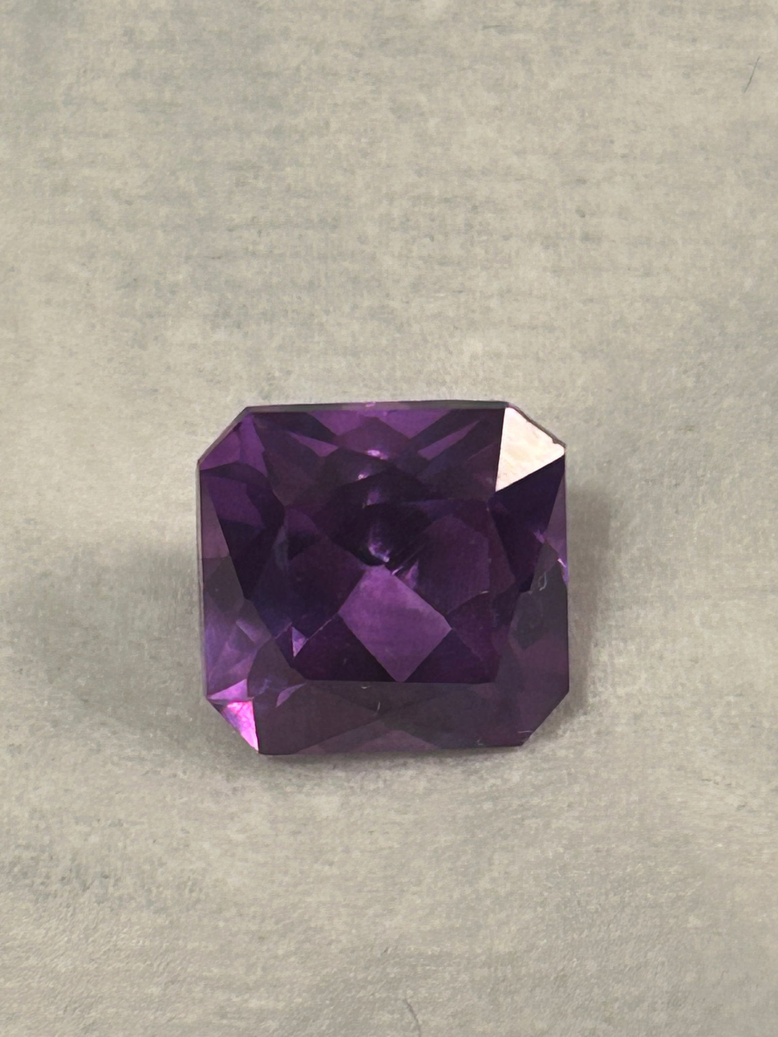 Alexandrite 11.65 ct Asscher cut. from Brazil: a exceptionally large, rare, and certified, untreated gemstone. Originating from Brazil, it is known for a dramatic color change from bluish green in daylight to purple red under incandescent light.