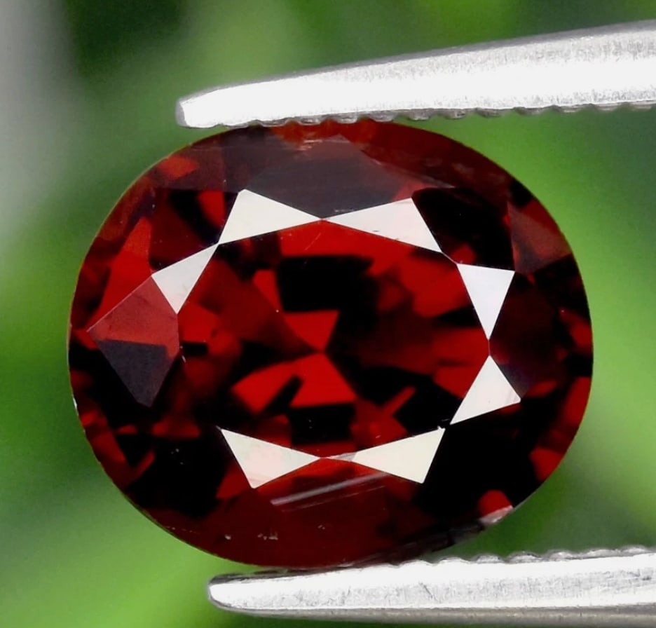 Orangish Red Spessartite Garnet Oval Cut VVS 1.6ct from Nigeria: This stones vibrant, manganese-caused orange-to-red hue, high clarity for its type, and rarity, its a desirable collector's stone, often sought after for its intense color like Mandarin Garnet,