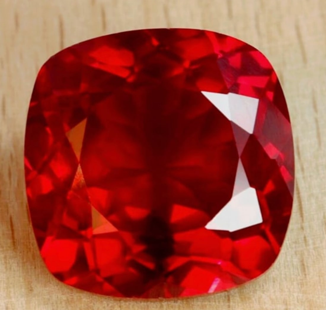 Blood Ruby 11 ct Cushion Cut VVS from Burma: top-tier gemstone, often showcasing a prized "pigeon blood" red hue due to high chromium content. Sourced from Burma, these natural, often unheated, rubies are highly sought after for their vivid, dee