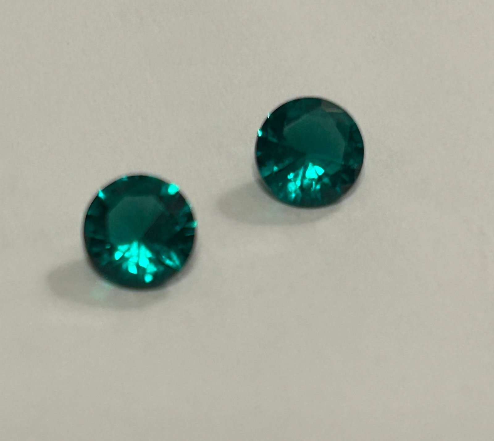 Colombian Green Emerald 2 ct Round Cut PAIR 6mm No Reserve: highly coveted for its intense, vivid green color, often enhanced by minor, traditional oiling. These stones originate from famed Colombian mines, boasting superior transparency and, when round-cut,,