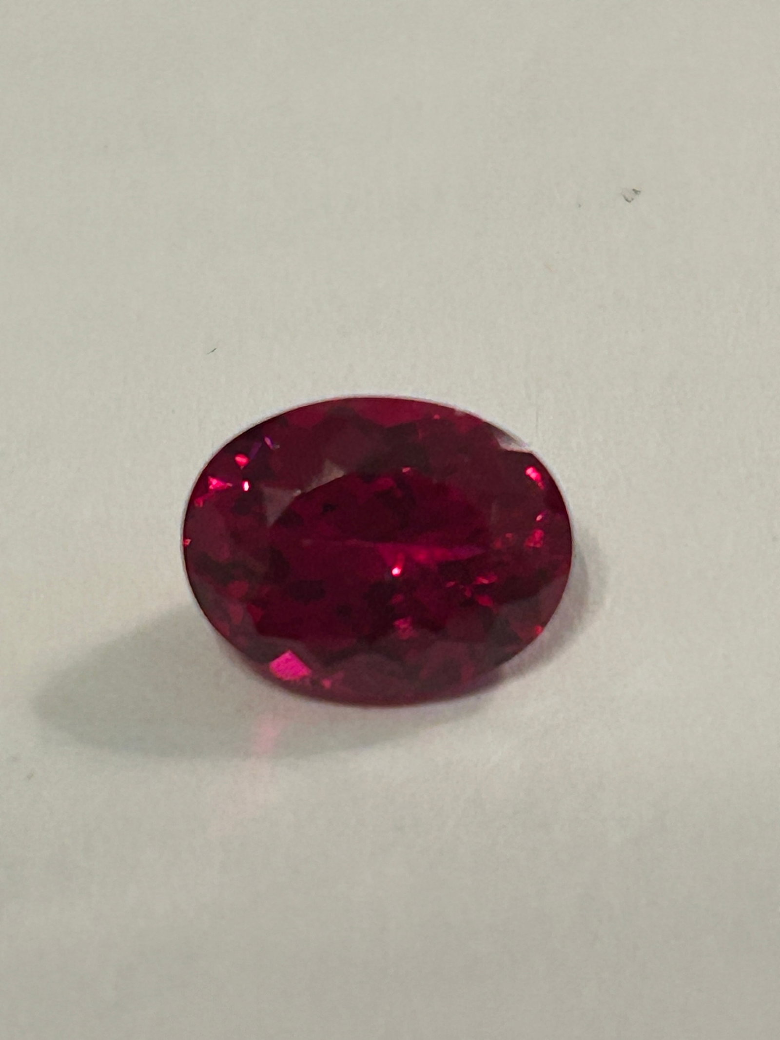 Stunning Natural Red Painite 3.85 Ct Oval cut: An exceptionally rare, top-quality Burmese gemstone featuring a brilliant oval cut. Sourced from Mogok, Myanmar, this faceted, eye-clean stone boasts a vibrant, deep red color.
