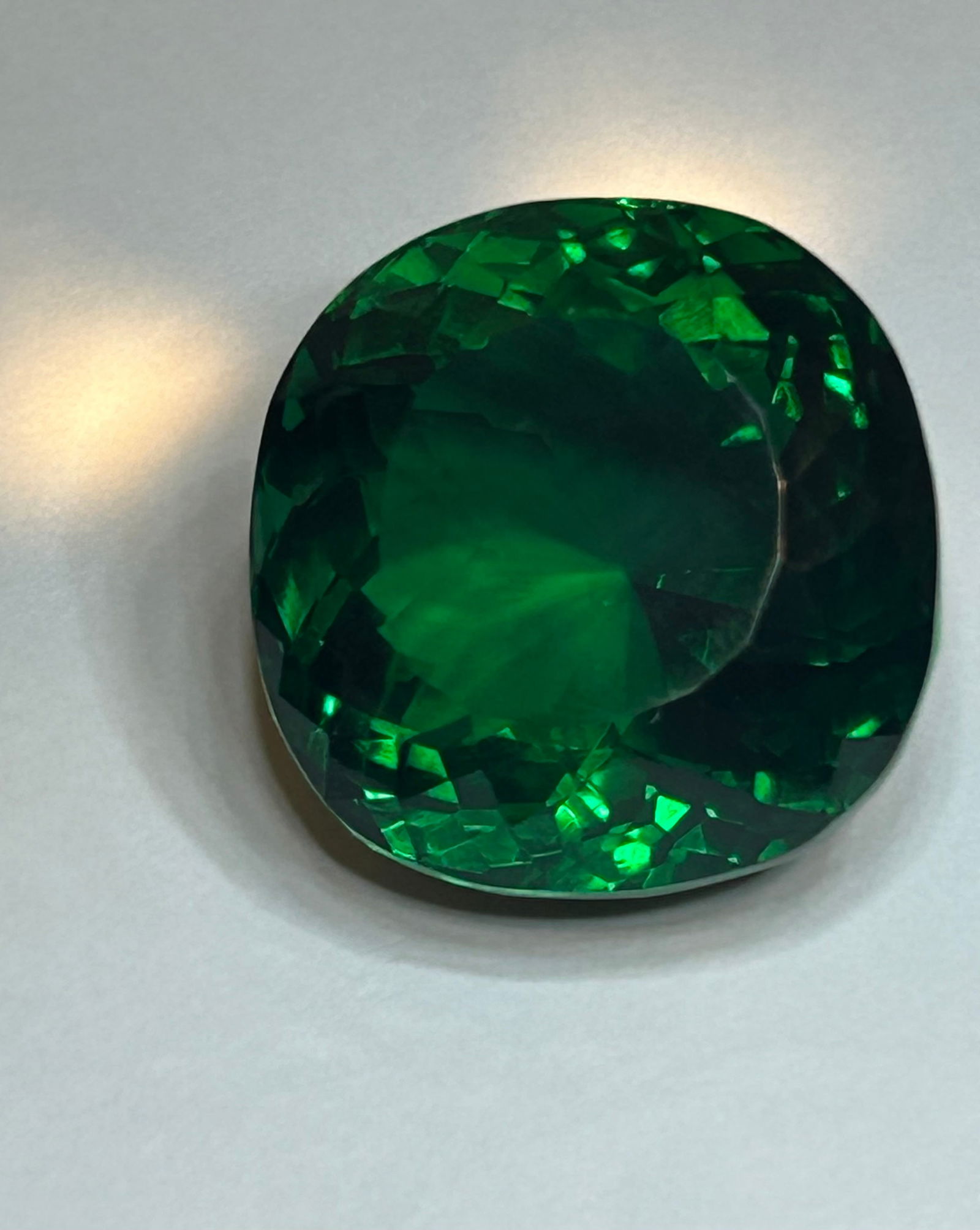 BIIIIGGGG!! 140ct Tsavorite Cushion Cut NO RESERVE: characterized by its intense, vivid green color, exceptional brilliance, and durable nature. As a member of the garnet family, this stone is mined in Kenya) and is known for having an electric green