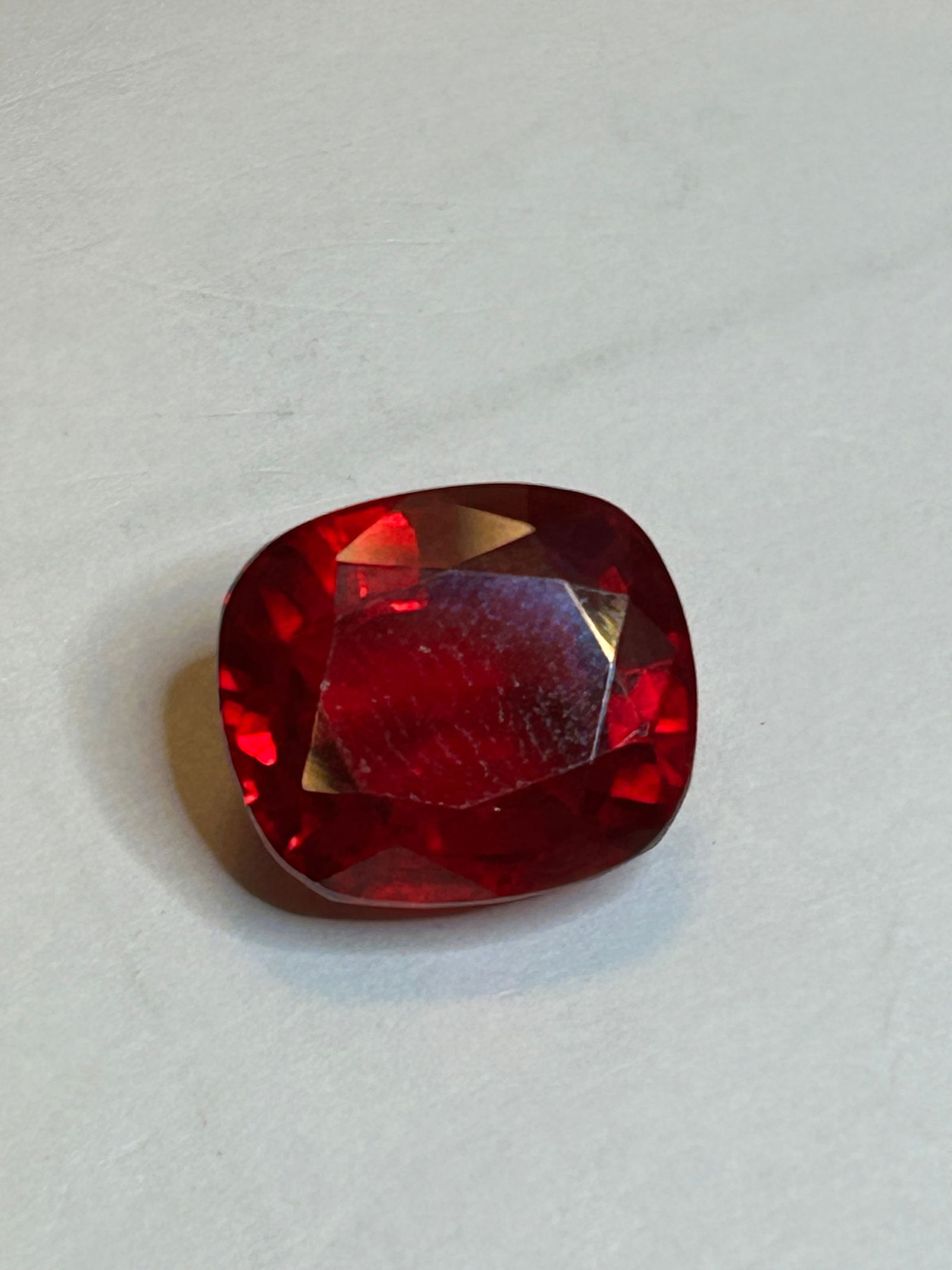 Ruby 15.5 ct Oval Cushion Cut transparent: significant brilliance from expert polishing, and high transparency.