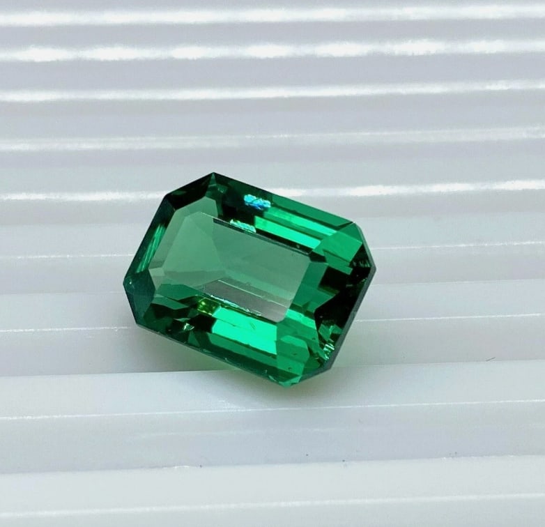 Natural Tsavorite 7.9ct Emerald Cut from Tanzania LOOKS LIKE AN EMERALD: This is a rare and large 7.9-carat natural Tsavorite, sourced from the Manyara region of Tanzania. It features a sophisticated emerald cut (step cut) that highlights its intense, vivid green color, of