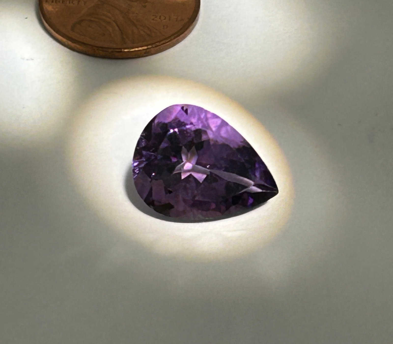 Natural Amethyst 7.44ct PEAR Cut from Brazil: a substantial, teardrop-shaped gemstone, typically featuring a vibrant purple hue, often with deep red or blue flashes, and is prized for its clarity and fiery sparkle. As a variety of quartz