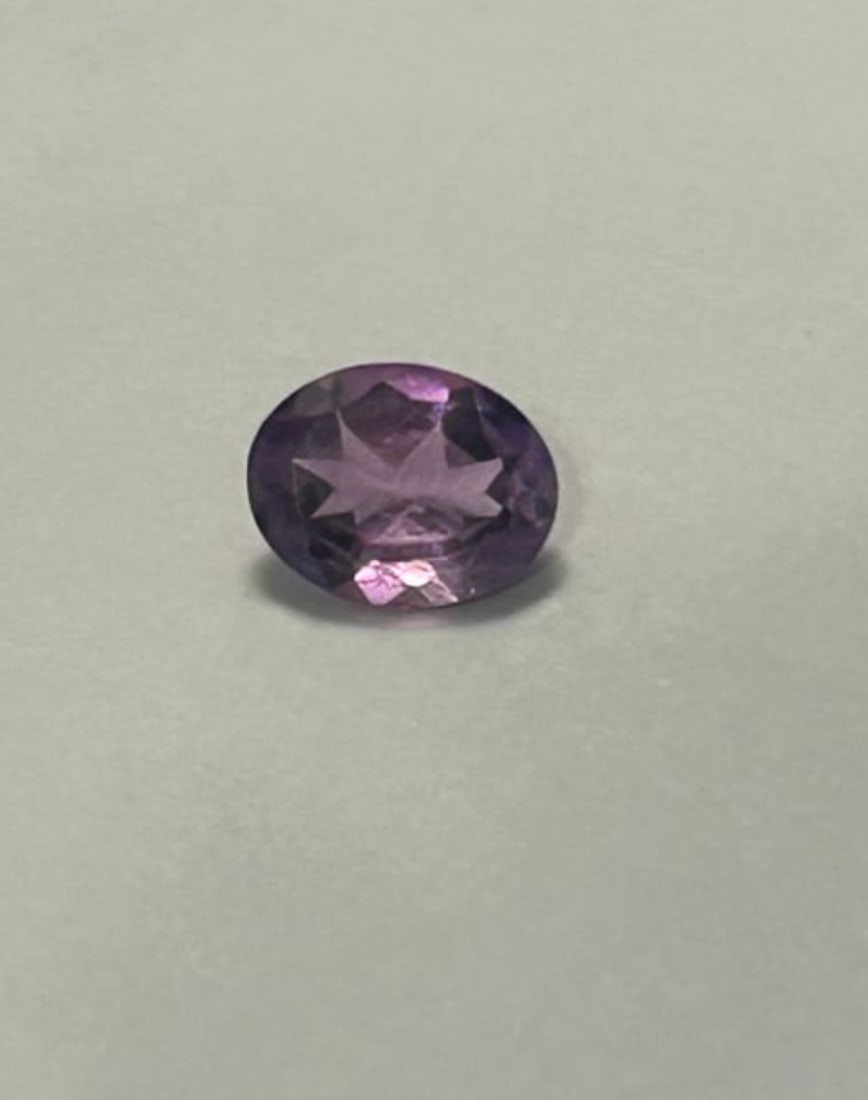 Amethyst 1.58 ct Oval Cut Nice Color from Brazil: a desirable purple hue, typical of high-quality Brazilian gemstone, which displays a lively, bright violet color. The oval cut enhances its brilliance and is ideal for various jewelry applications,