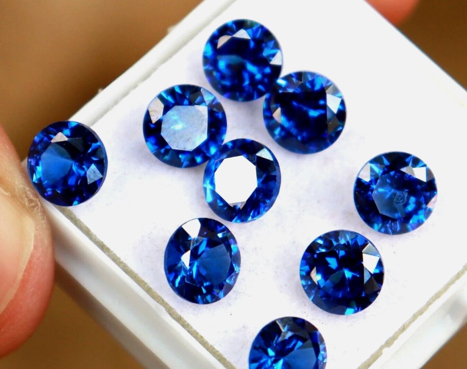 Authenticed Ceylon Blue Sapphire Round Cut 6mm 10 Pcs from Sri Lanka: Features vivid, eye-clean, natural blue sapphires with an excellent cut, ideal for jewelry, known for their bright, distinctive cornflower blue, with certification confirming quality, offering value