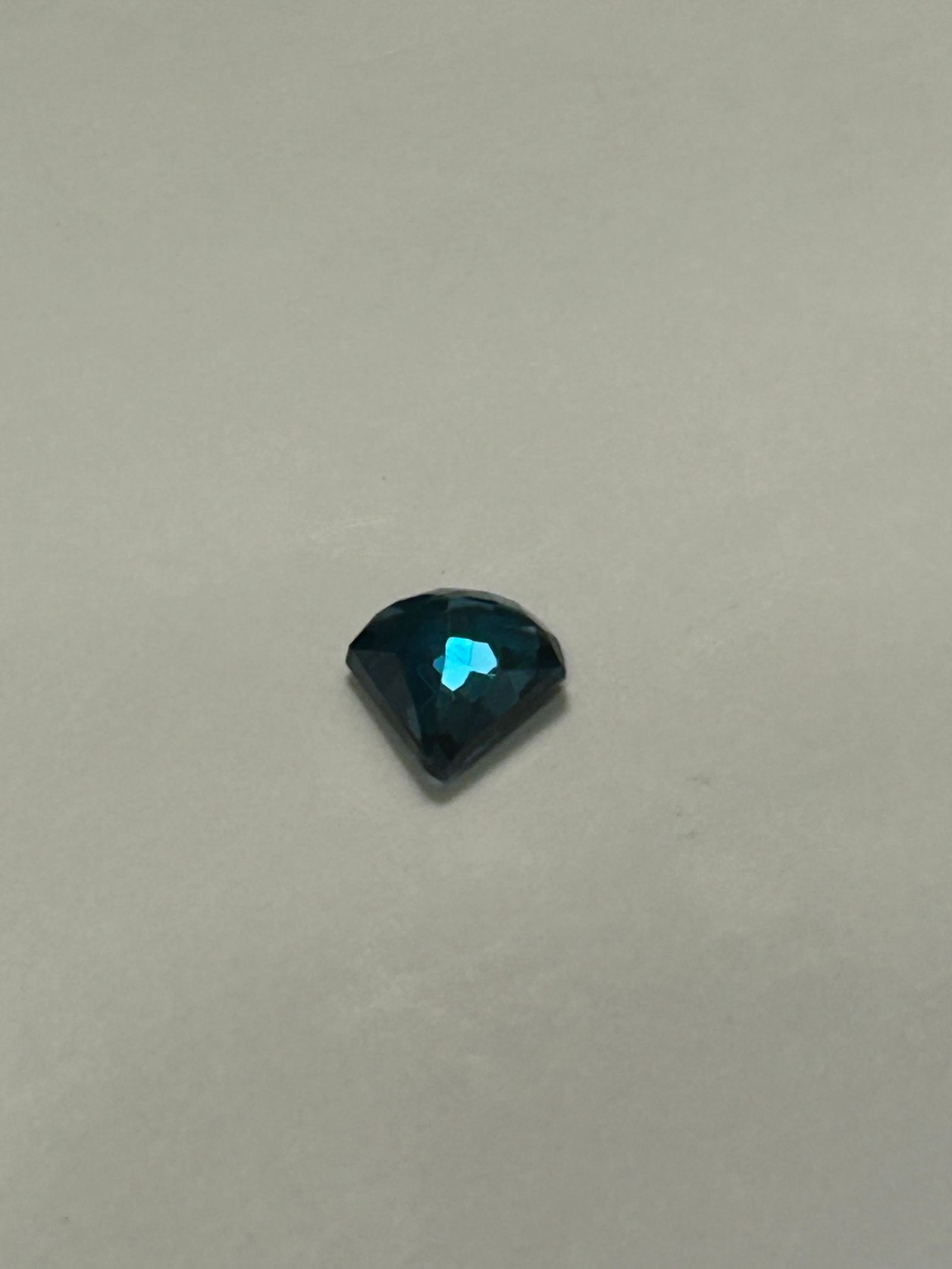 Natural London Blue Topaz 3.92 ct Fancy Cut from Brazil: This 3.92 ct natural London Blue Topaz from Brazil features a deep, moody blue-grey hue, is expertly cut in a fancy shape to maximize sparkle. Known for its durability, this untreated, earth-mined