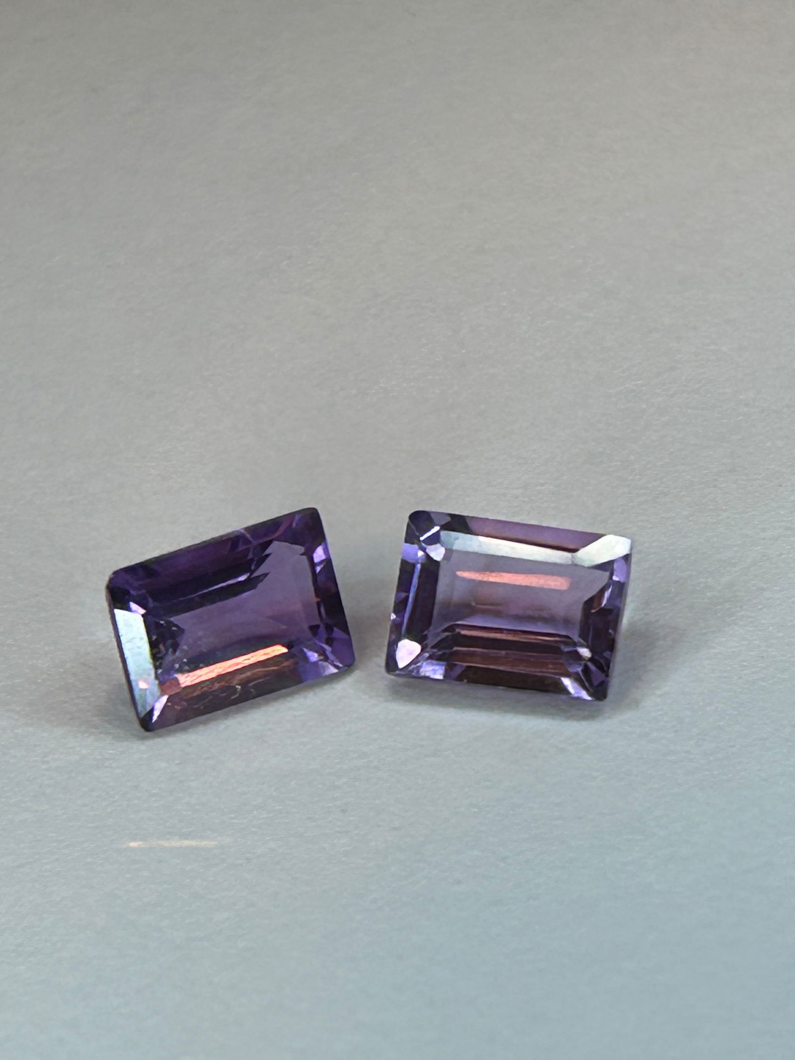 Natural Amethyst 0.99ct Round Cut PAIR: Features a classic Emerald cut, ideal for earrings or matching jewelry sets. These stones are violet-purple in color sourced from Brazil and exhibit high clarity (VVS).