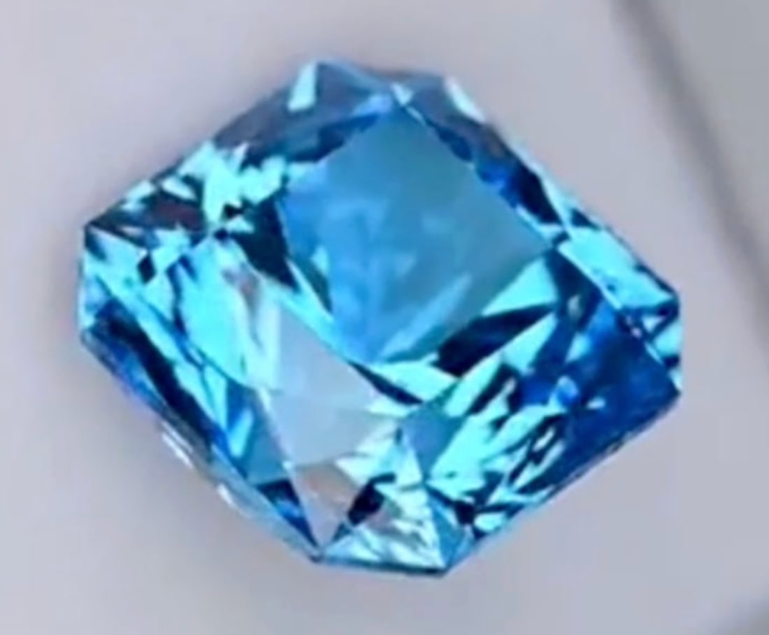 Neon Blue Paraiba Tourmaline Asscher Cut VVS 11.85ct from Brazil: an exceptionally rare, high-value gemstone, characterized by its electric, tropical blue-green hue (the "neon" glow from copper), significant size (11.85 carats), Asscher cut for brilliance, VVS clari