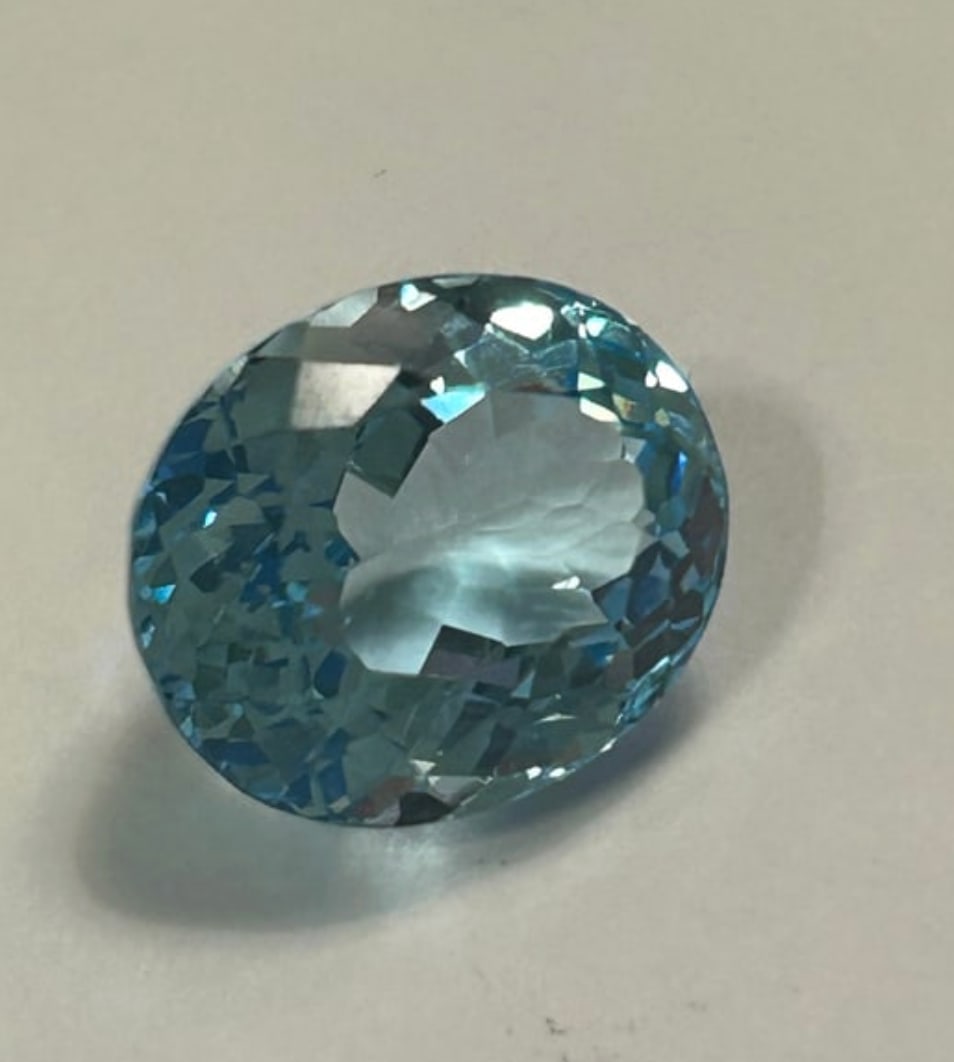 Natural Sky Blue Topaz 14.58ct Oval Cut From Brazil: Sky Blue Topaz from Brazil is a substantial, pale-blue, transparent gemstone, Light, serene color. Mined in Brazil, this large, faceted gem offers excellent clarity and a high-value.