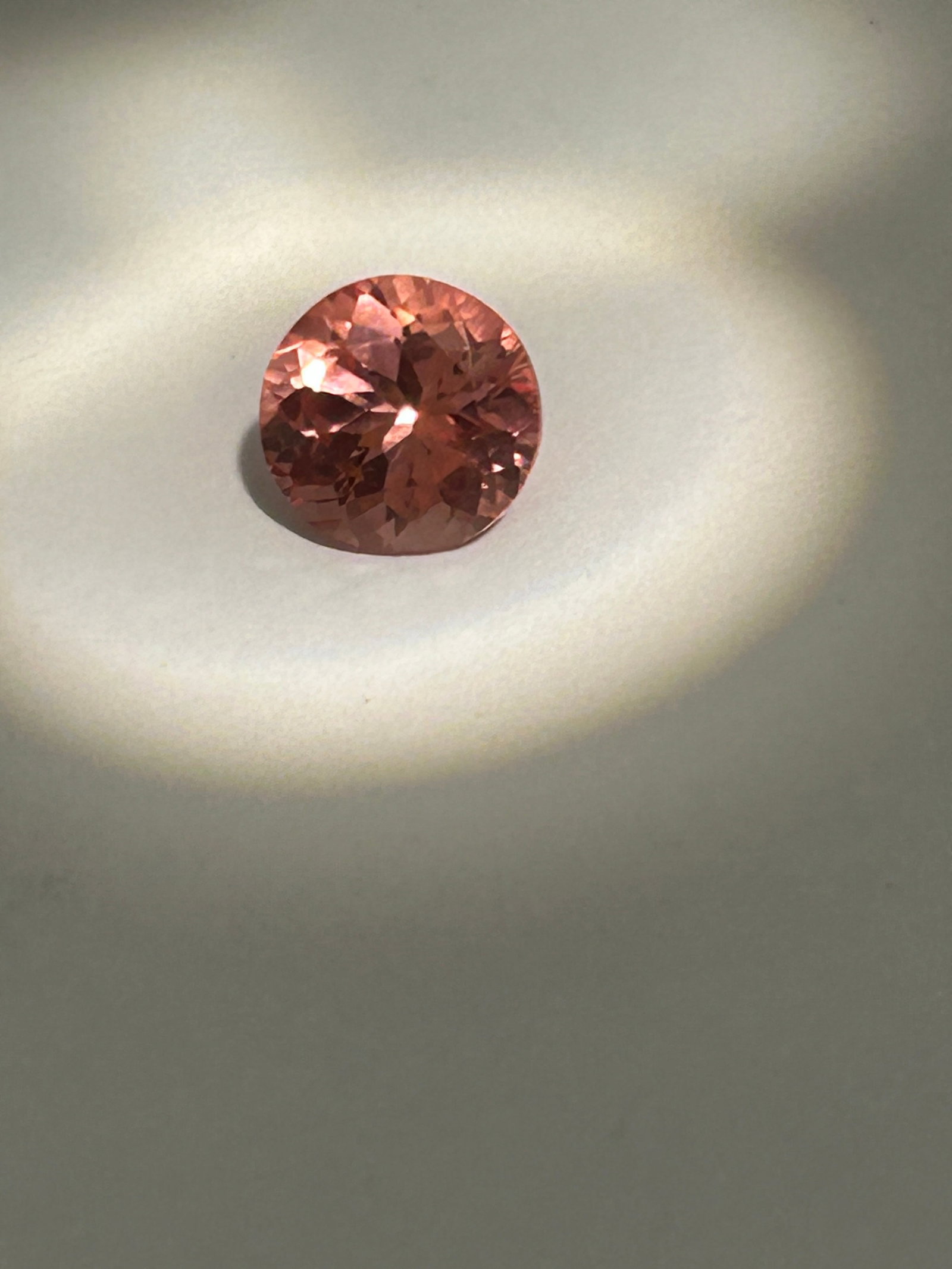 Padparadscha Sapphire 5ct Round Cut No Reserve GIE Certified: showcasing a delicate, vibrant mixture of pink and orange hues, reminiscent of a lotus blossom or sunset. At this large size, they are considered investment-grade treasures. The round brilliant cut ma