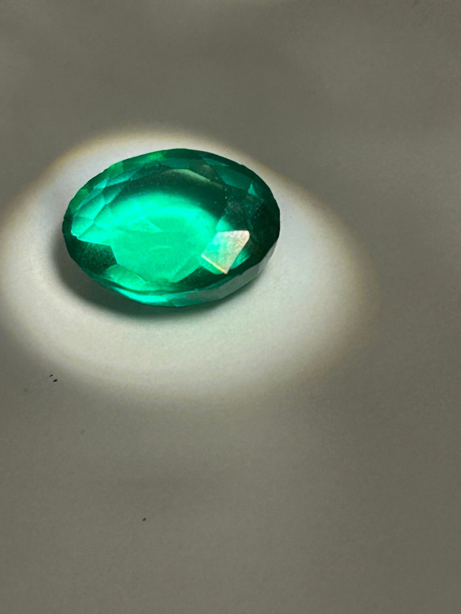 8.45ct Emerald Oval Cut IGL Certified No reserve Lab Grown: An 8.45ct emerald-cut lab-grown emeraldfeatures a step-cut facet pattern, producing a sophisticated, linear look. High-quality VVS2 clarity, and excellent polish/symmetry, with elongated rectangular s