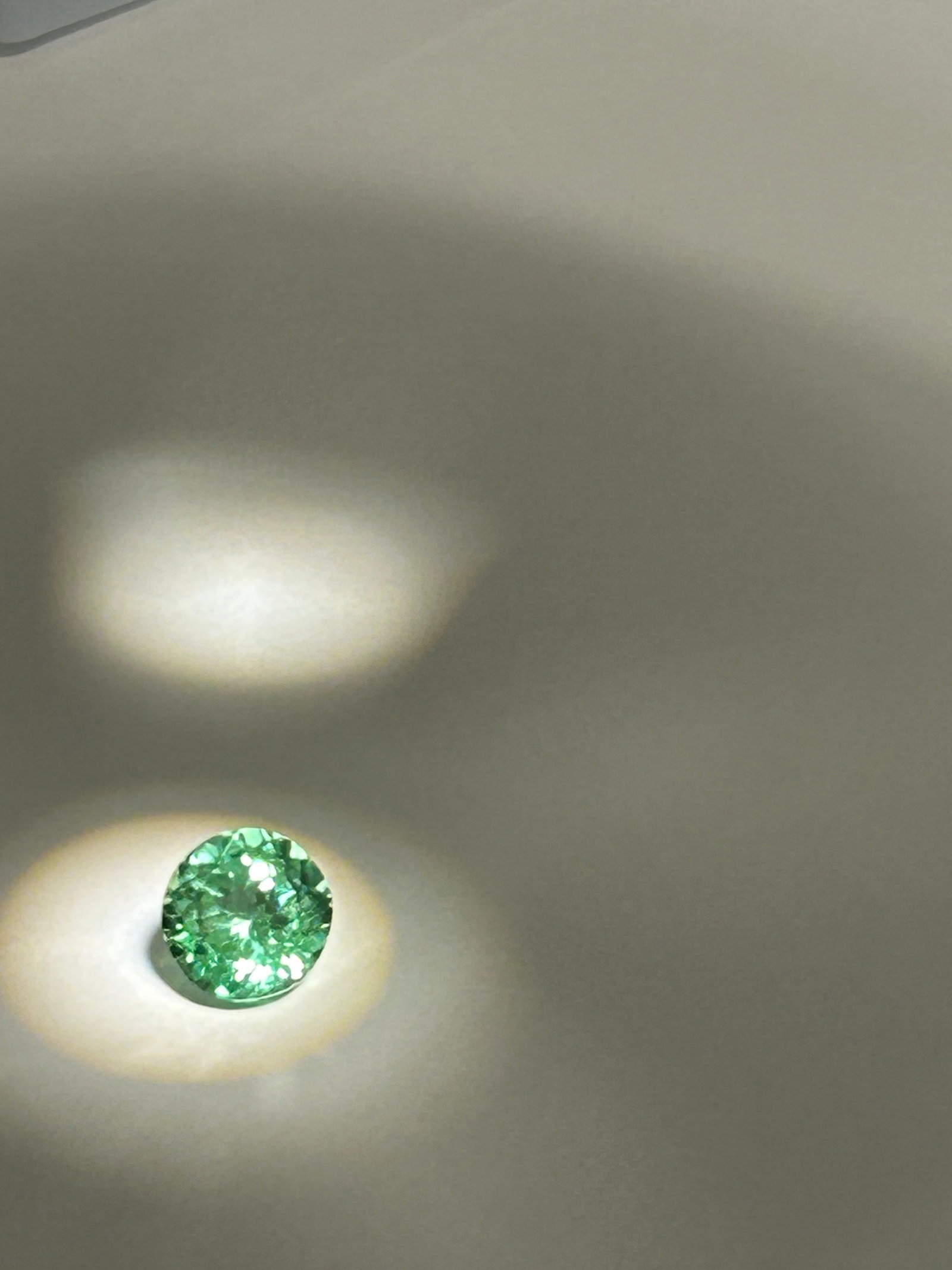 4.25ct Montana Green Sapphire Round Cut No Reserve AGL Certified: A round-cut gemstone originating from Montana, USA. It features intense, natural, unheated green coloring and superior brilliance. Graded as VVS clarity.