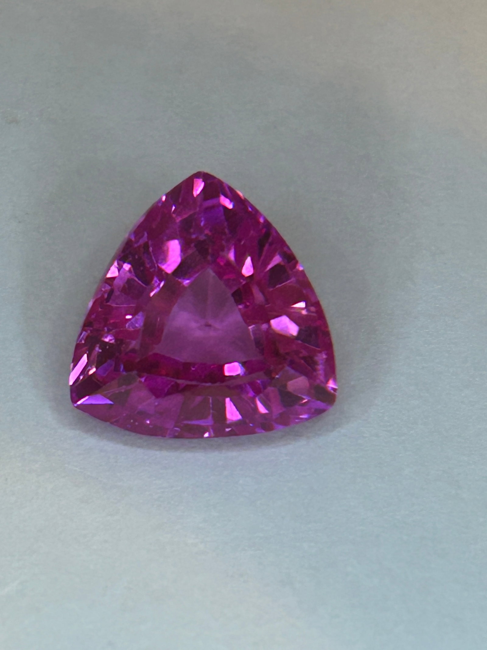 12.55ct Ceylon Neon Pink Sapphire Trillion Cut No Reserve EGL Certified FINAL ITEM: Tremendous clarity graces this gemstone. Evaluated at eye level, it carries very slight inclusions, mere reminders of its earthly birth, adding authenticity to its ethereal glow. The vivid color inten