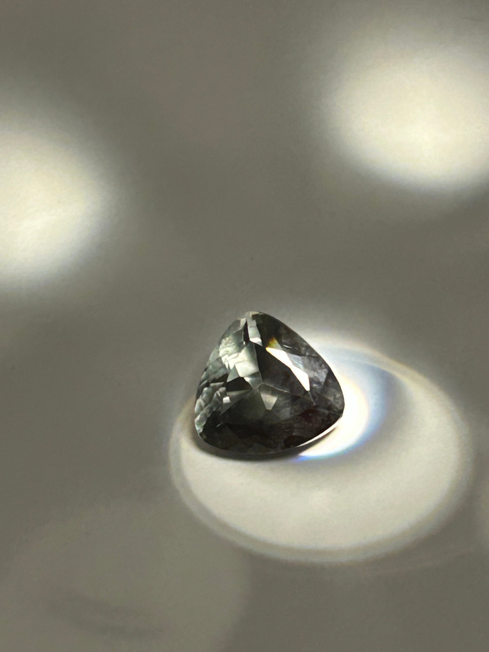 9ct Kenyan Smoky Green Tsavorite Trillion Cut: Cut in a Trillion is an exceptionally showcasing a deep, smoky green with moderate inclusions. Sourced from Kenya. this The trillion cut designed to enhance brilliance, balancing a dark, moody tone wi