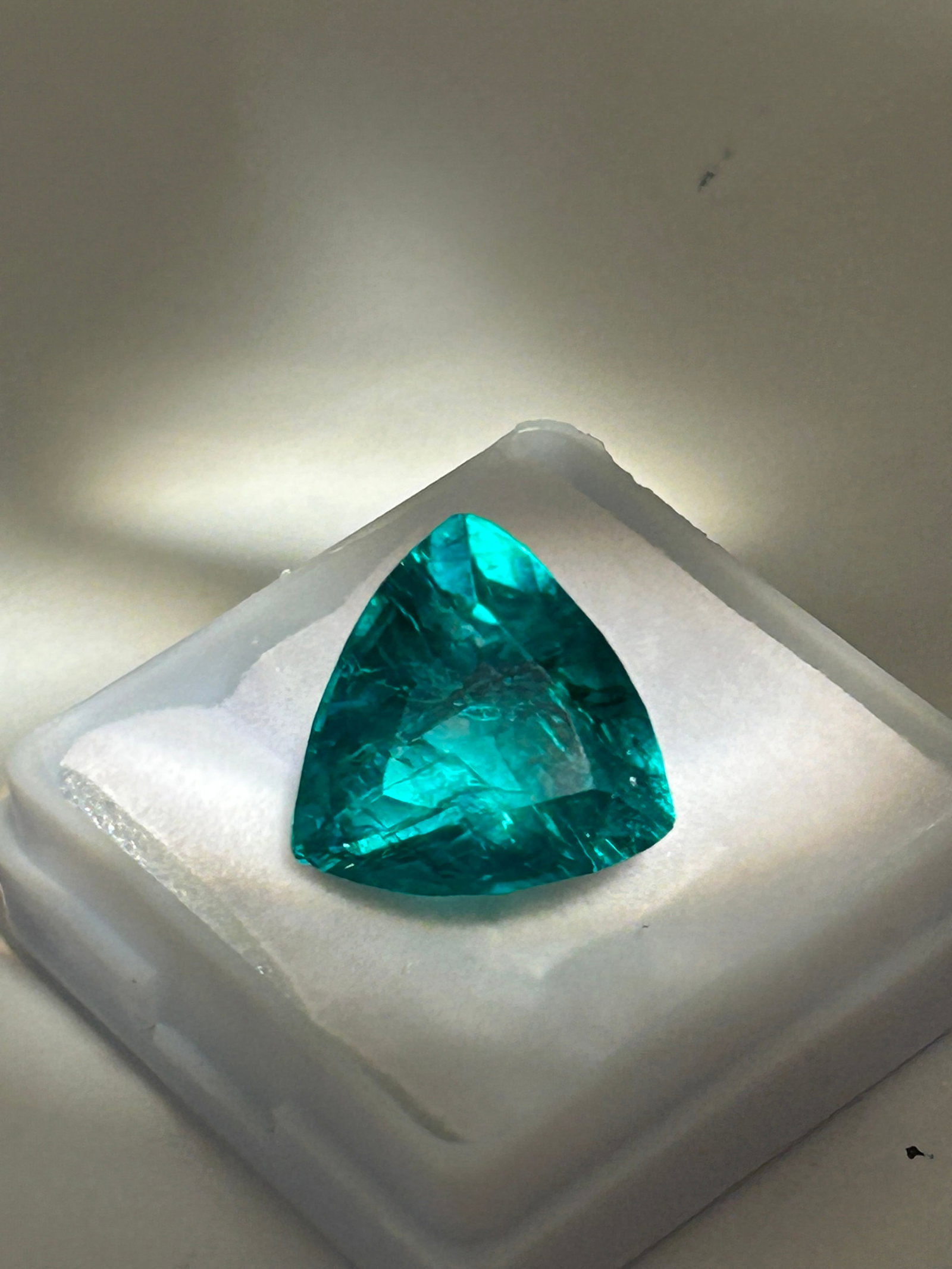 5ct Colombian Emerald Trillion Cut No Reserve two of two: Known for superior, warm, intense green hues, these stones often have natural inclusions (jardin) and are typically treated with oil to enhance clarity. It offers a modern, fiery sparkle compared to t