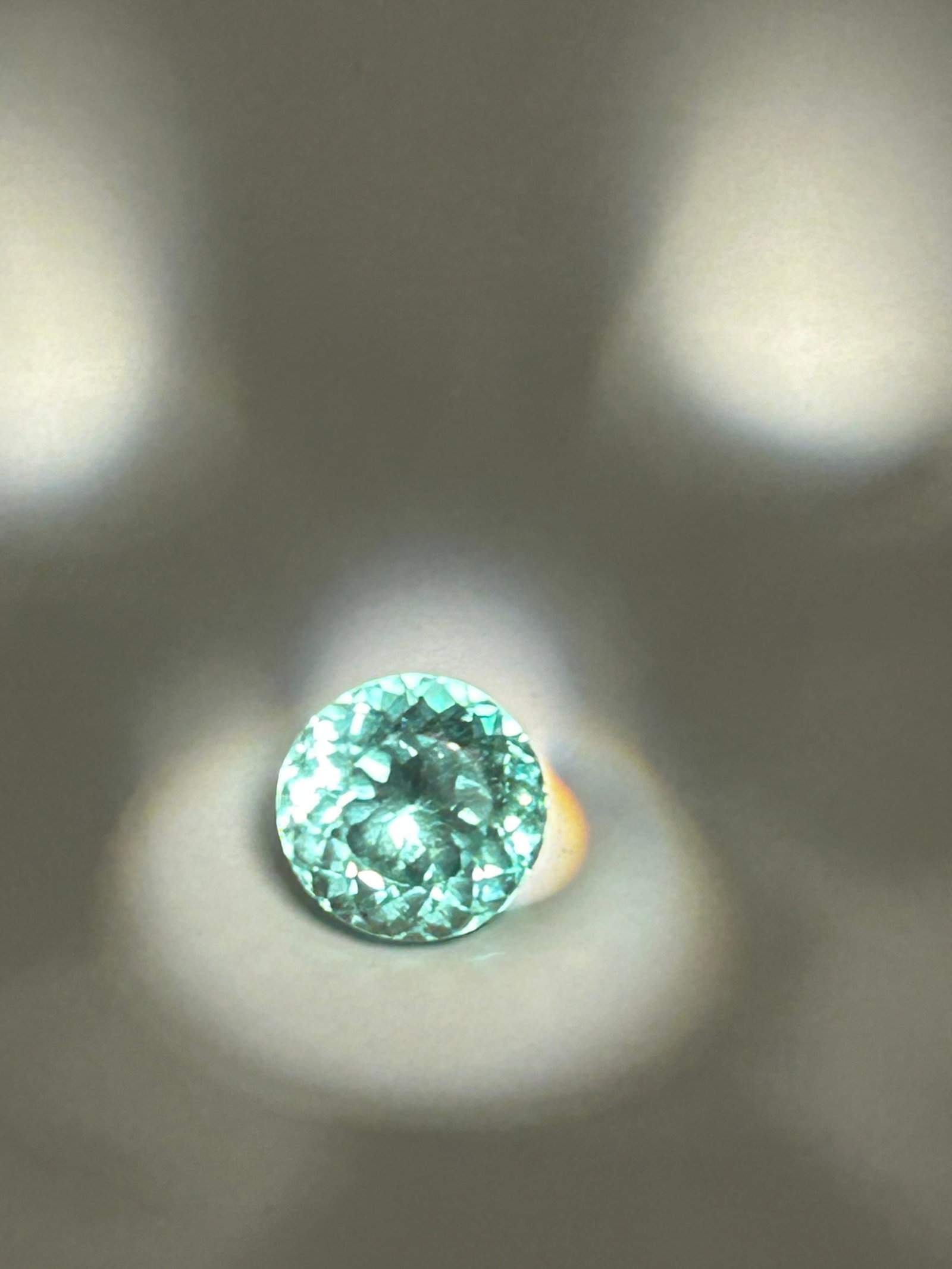5.2 Ct Intense Brazilian Green Sapphire Round Cut No Reserve GIR Certified: Vibrant, and rare gemstone, likely to be used for a statement ring or pendant. It features a rich, saturated pale green hue. Round cuts on this sized stone are designed to maximize brilliance and colo