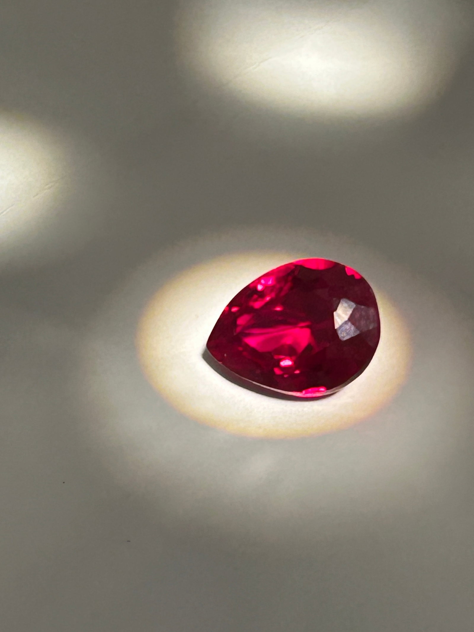 7.9 Carat Mozambique Blood Ruby Pear Cut GIR Certified: An exceptional gemstone characterized by a vibrant, "pigeon blood" red hue, high saturation, and intense brilliance. This stones feature mixed brilliant cutting to optimize light return, highlighting 