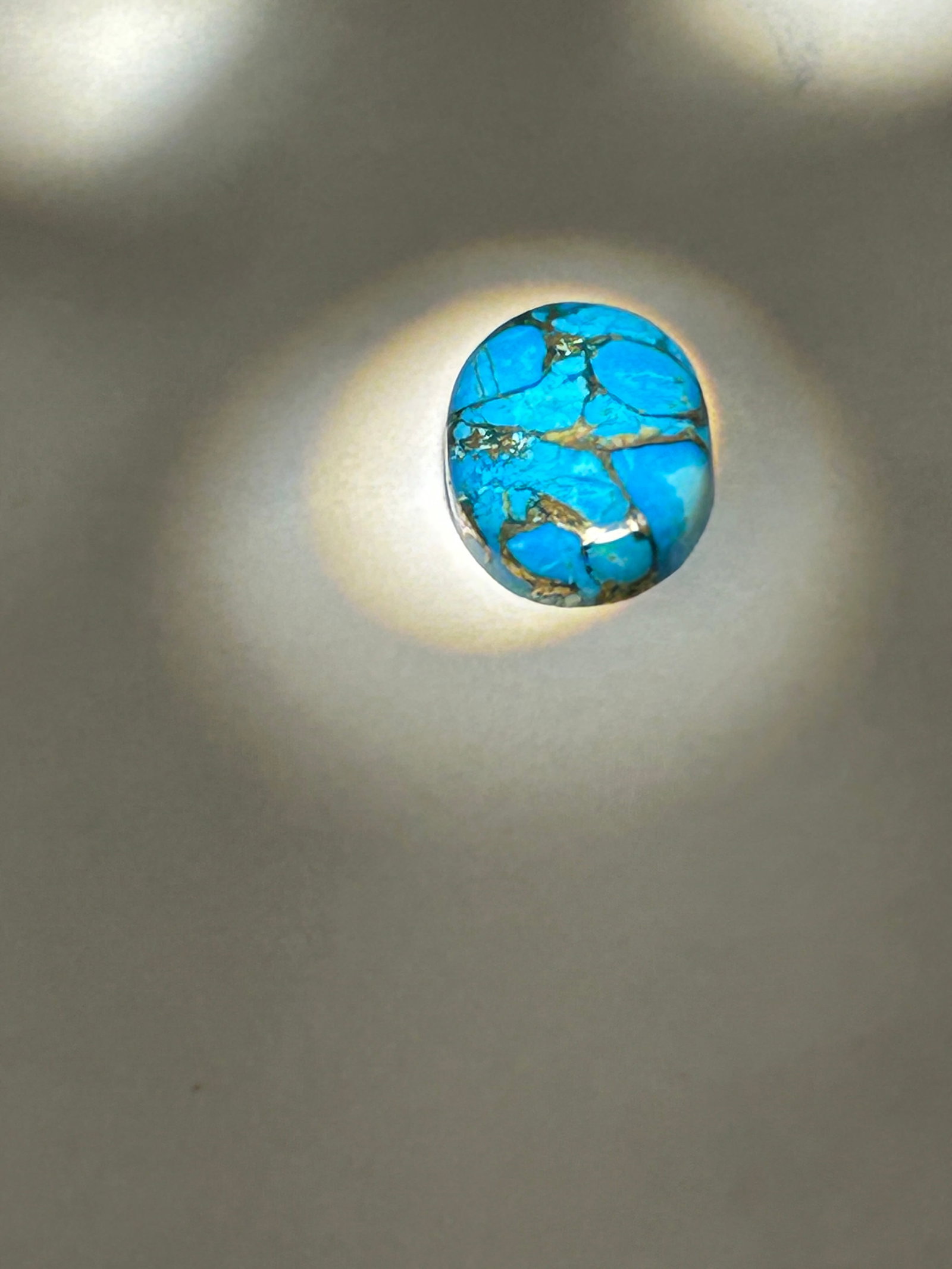 14 x 10mm Intense Blue Topaz Oval Cut IGI Certified: a popular, calibrated gemstone frequently used in jewelry making, known for its vibrant color contrasted with metallic matrix veins. These stones are usually sold as cabochons, featuring a smooth, pol