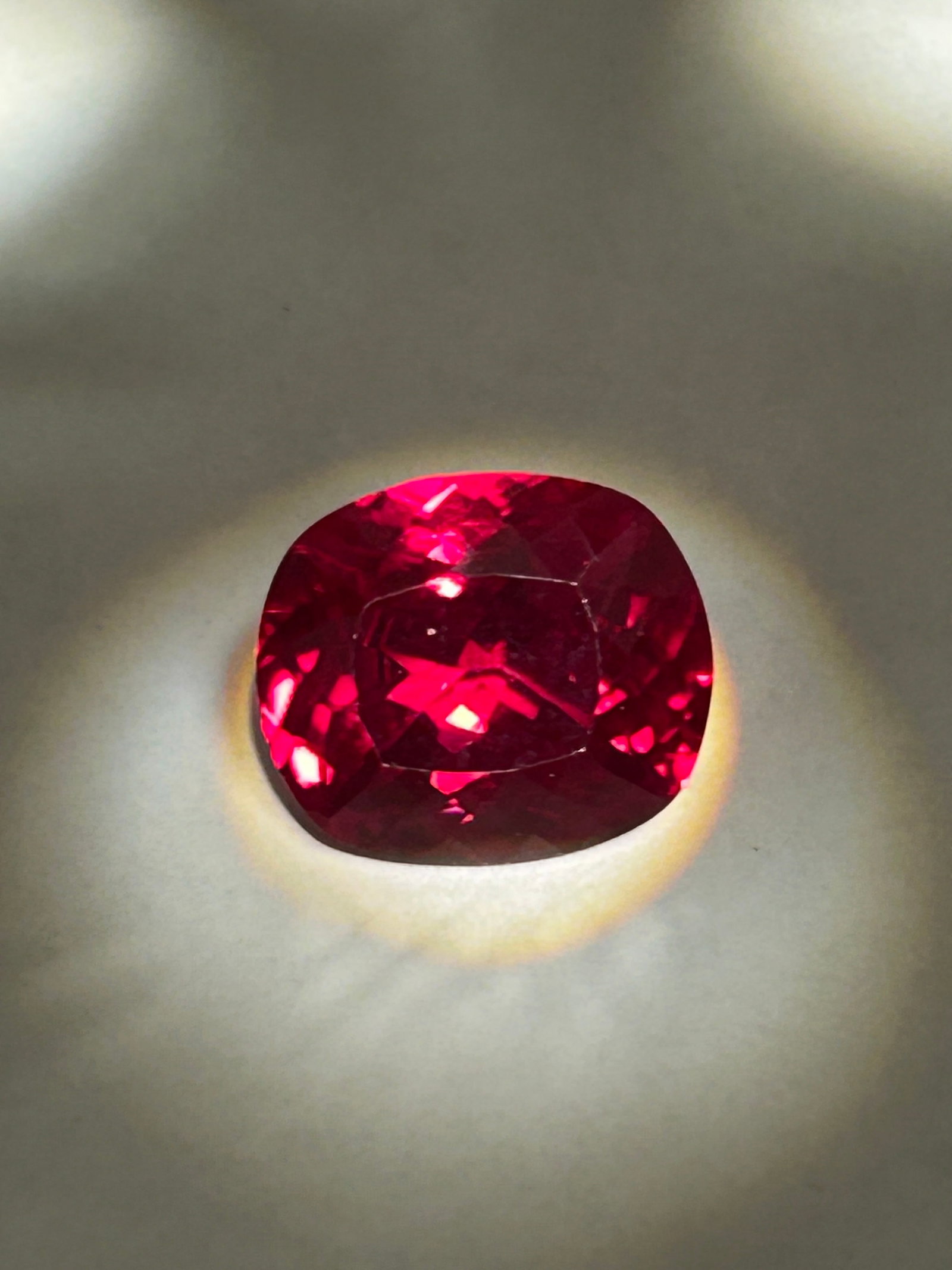 11.50 Carat Blood Ruby Oval Cushion Cut GGI Certified: Oval Cushion Cut (often a hybrid combining an elongated oval profile with the soft, rounded corners and deep faceting of a cushion cut) is a significant and high-impact gemstone. At this weight, the s