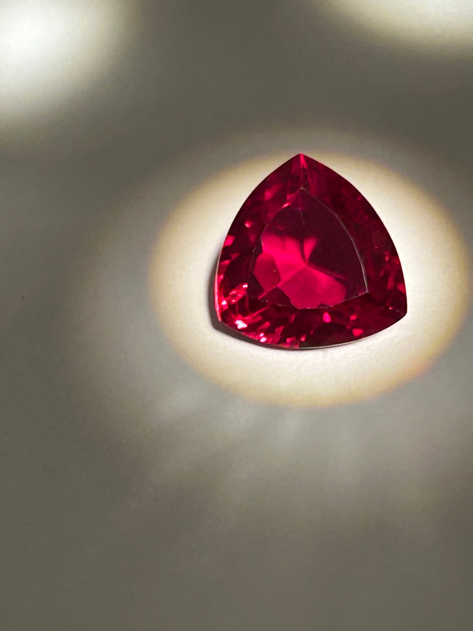 10 Carat Mozambique Blood Ruby Trillion Cut EGL Certified: A deep, intense red color—often termed blood Red—originating from Mozambique, known for high-quality, durable rubies. These stones feature high clarity and a modern, brilliant, triangular cut. Def