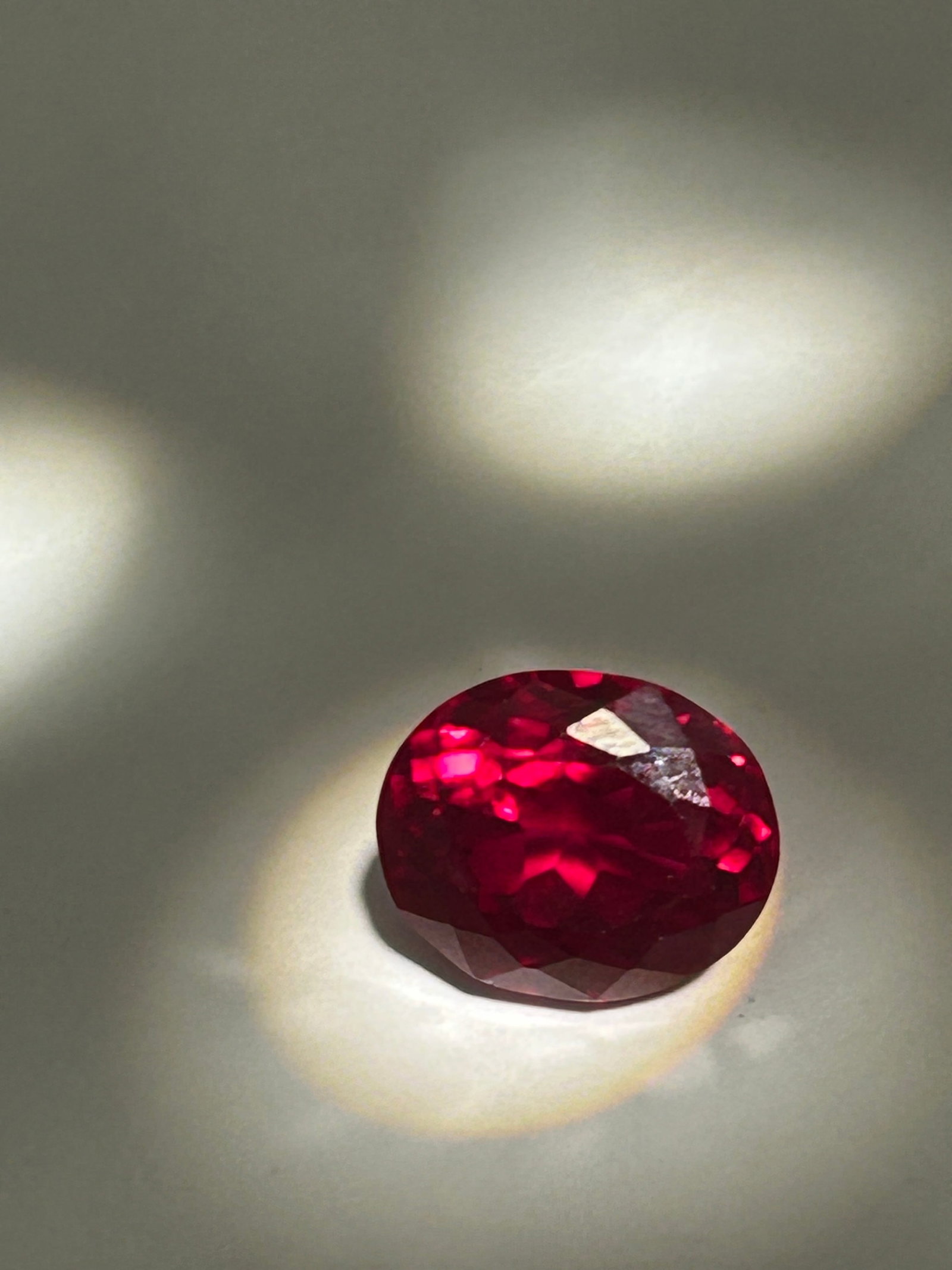 9.35ct Deep Red Ruby Modified Cushion Cut GGI Certified: high-impact gemstone that combines the classic appeal of a cushion shape with modern, precision faceting. Deep Saturation and luminosity make this a desirable centerpiece.