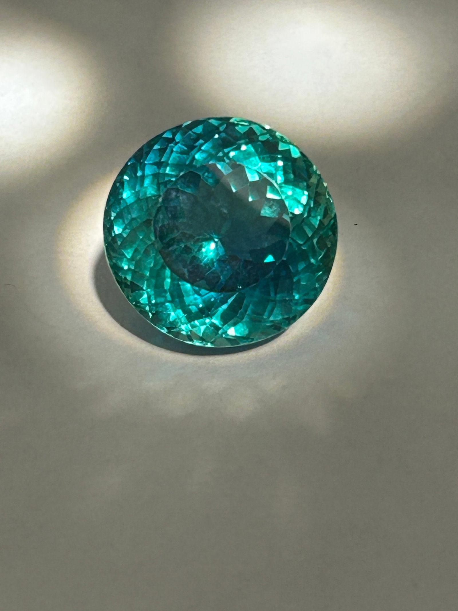 32.30 Carat Green Sapphire Round Cut GGI Certified: Combination of characteristics results in a substantial, eye-catching gemstone suitable for statement jewelry such as rings or pendants. Investment-grade gemstone suitable for statement jewelry.