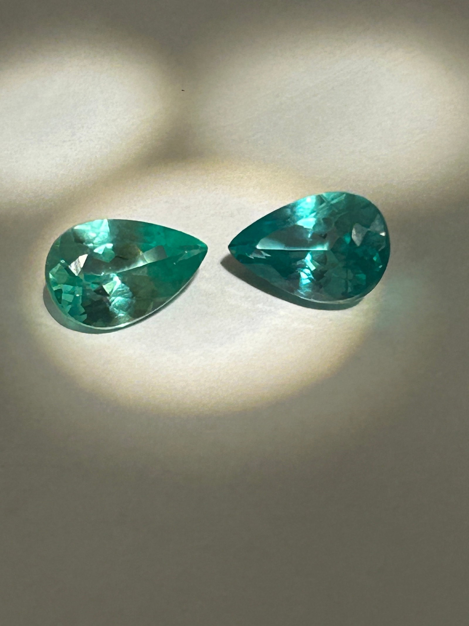12.45 Carat Green Sapphire PAIR Pear Cut GIR Certified: 12.45-carat total weight pair of green sapphire, shaped in a pear cut, is a substantial, high-quality set designed for luxury, such as earrings or a large statement ring. These gemstones feature a dis