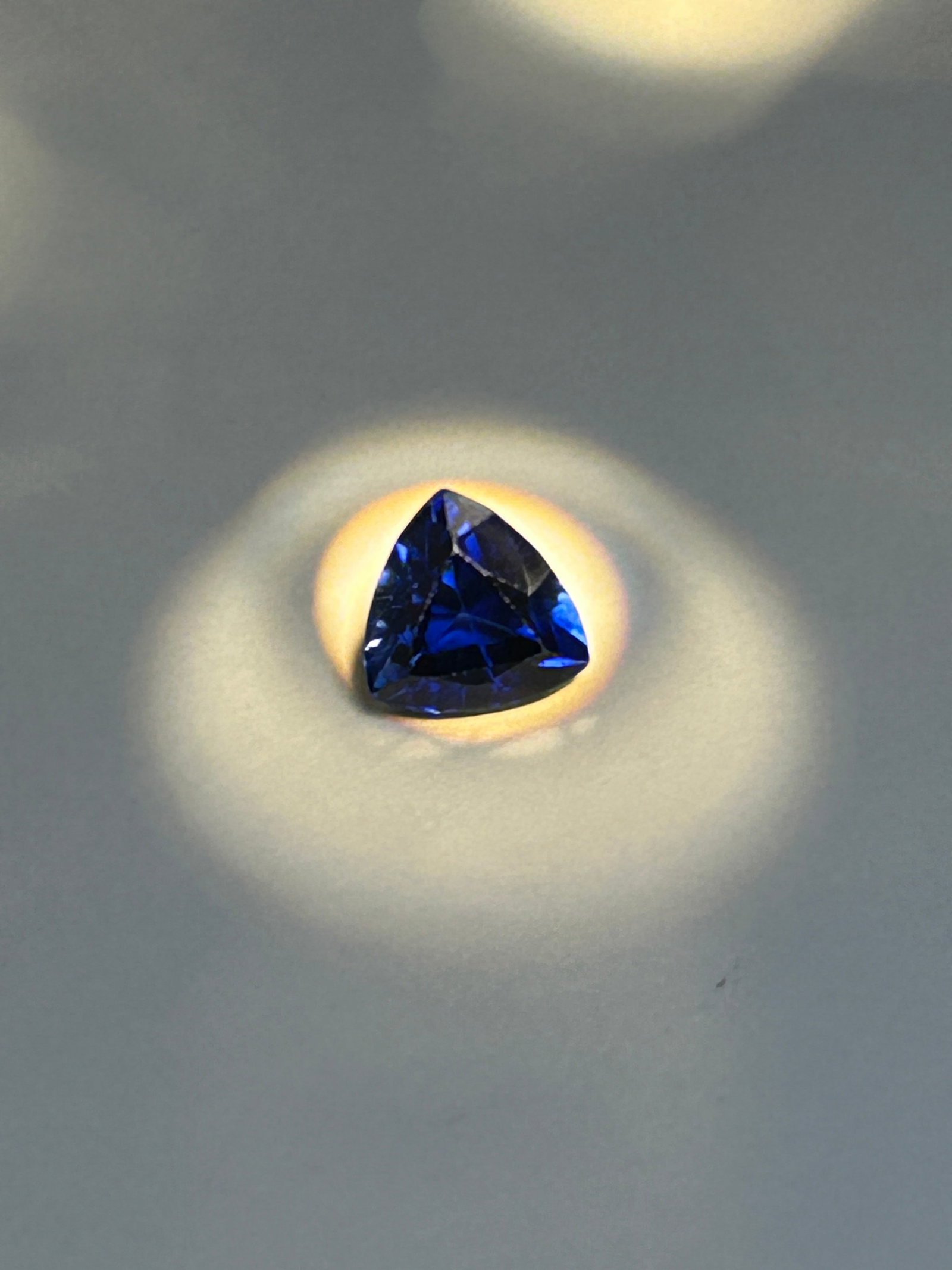 3.15 Carat Dark Blue Sapphire Trillion Cut Certified: a unique, triangular trillion cut, offering a brilliant and modern look. It generally presents a deep, rich dark blue color with eye-clean clarity. a substantial, modern gemstone. Based on typical