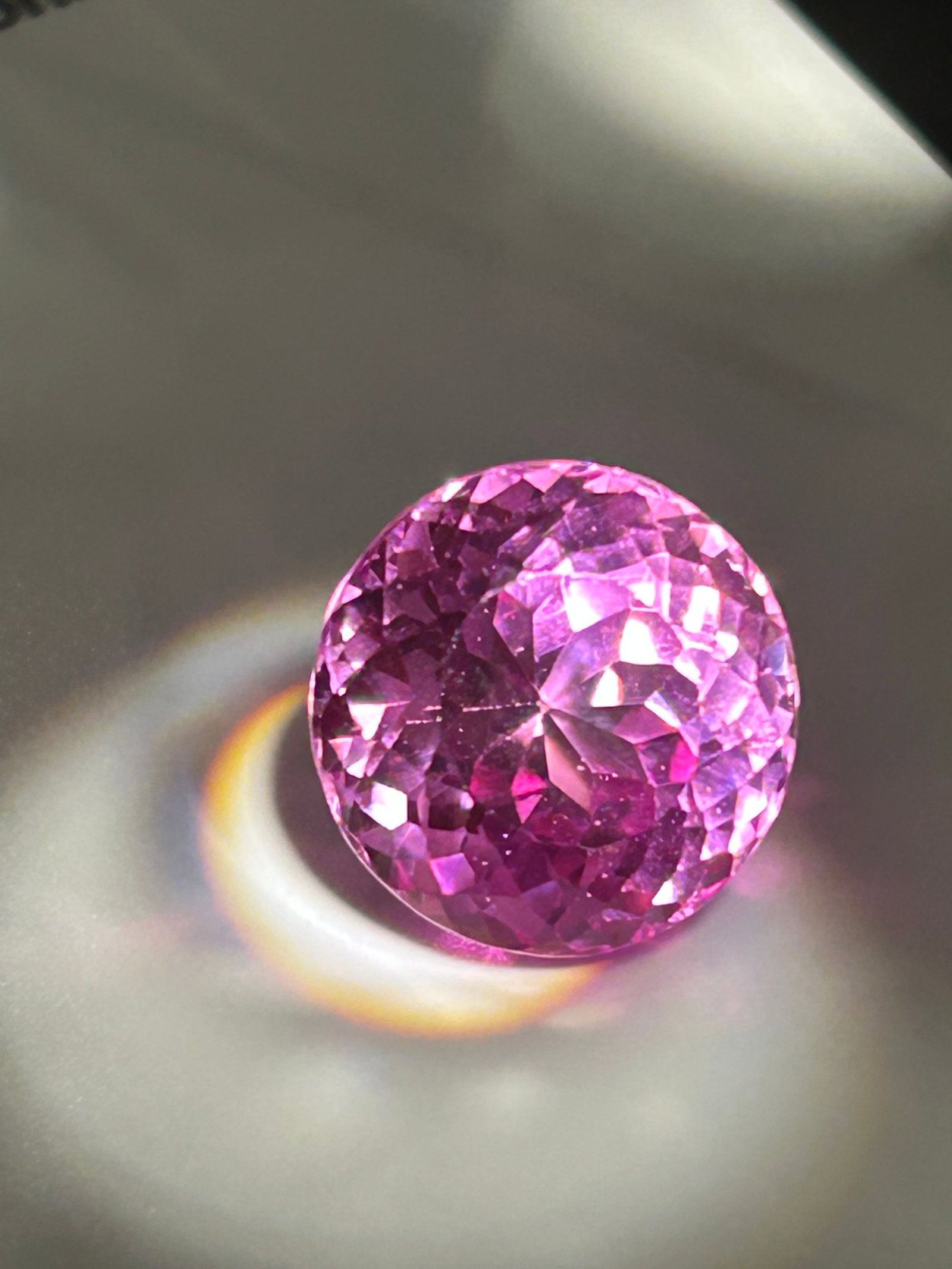 13.95 Carat Pink Sapphire Round Cut GIA Certified Lab Grown: an exceptionally large, lab-created gemstone often produced via the flame fusion (Verneuil) method, resulting in a highly saturated, "vivid hot pink" color. While similar in chemical composition (coru