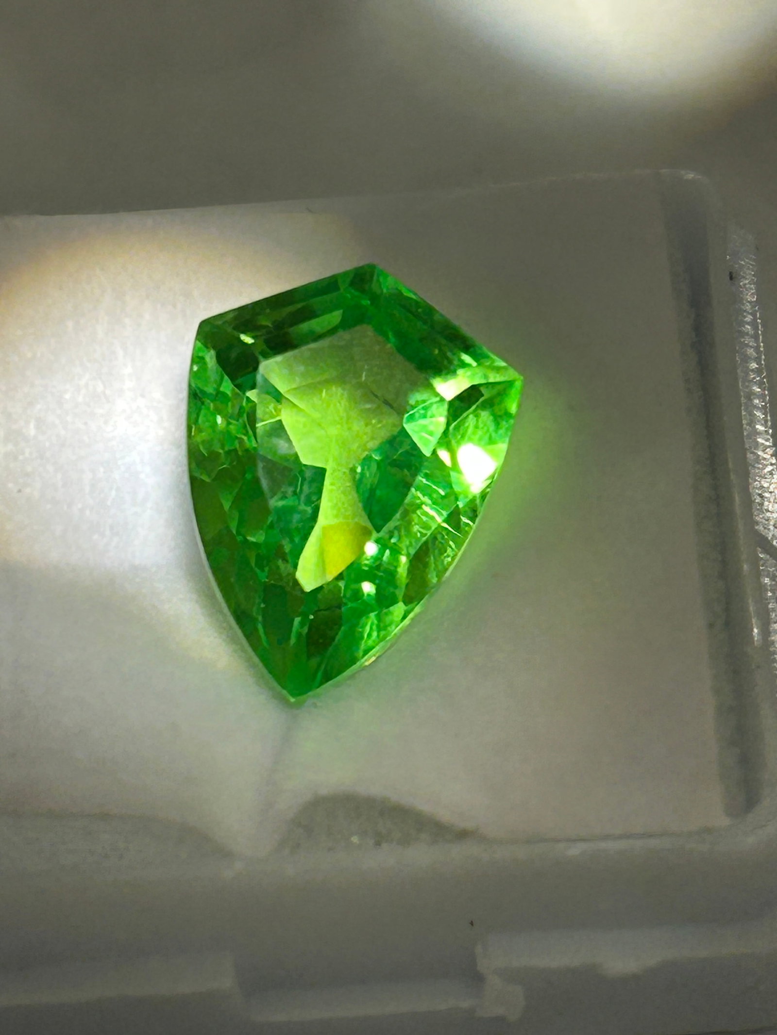 9.00 Carat Peridot Fancy Cut GGL Certified: collector-quality gemstone known for its vibrant, "lively" green hue and high transparency. Peridots of this size are rare, often exhibiting a rich olive or grass-green color due to higher iron conten