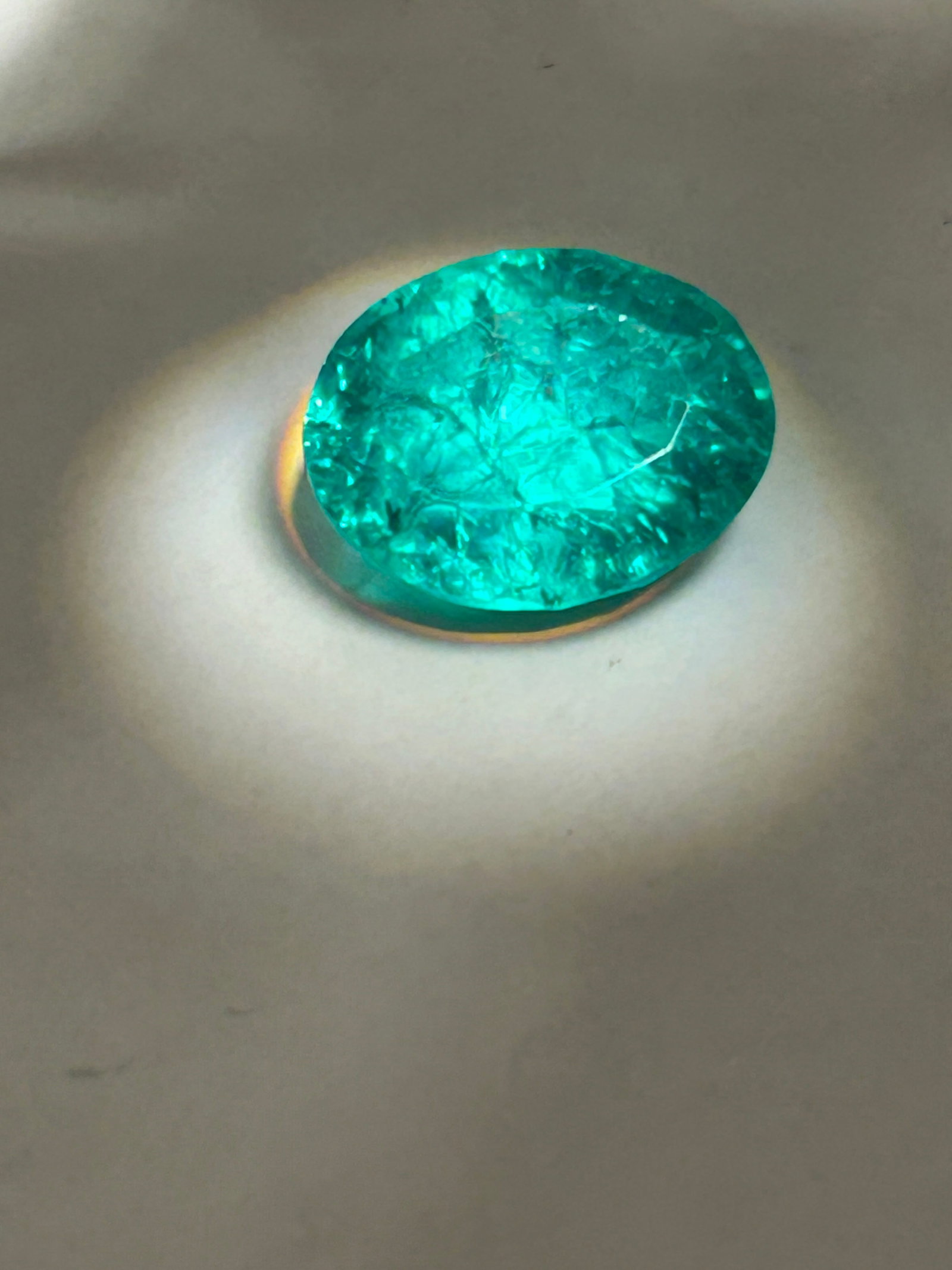 10.30 Carat Emerald Oval Cut GGL Certified: an oval-cut, vivid green, eye-clean stone, likely sourced from Brazil or Colombia, and often treated to enhance its color. It is characterized as a large gemstone suited for high-jewelry statement pie
