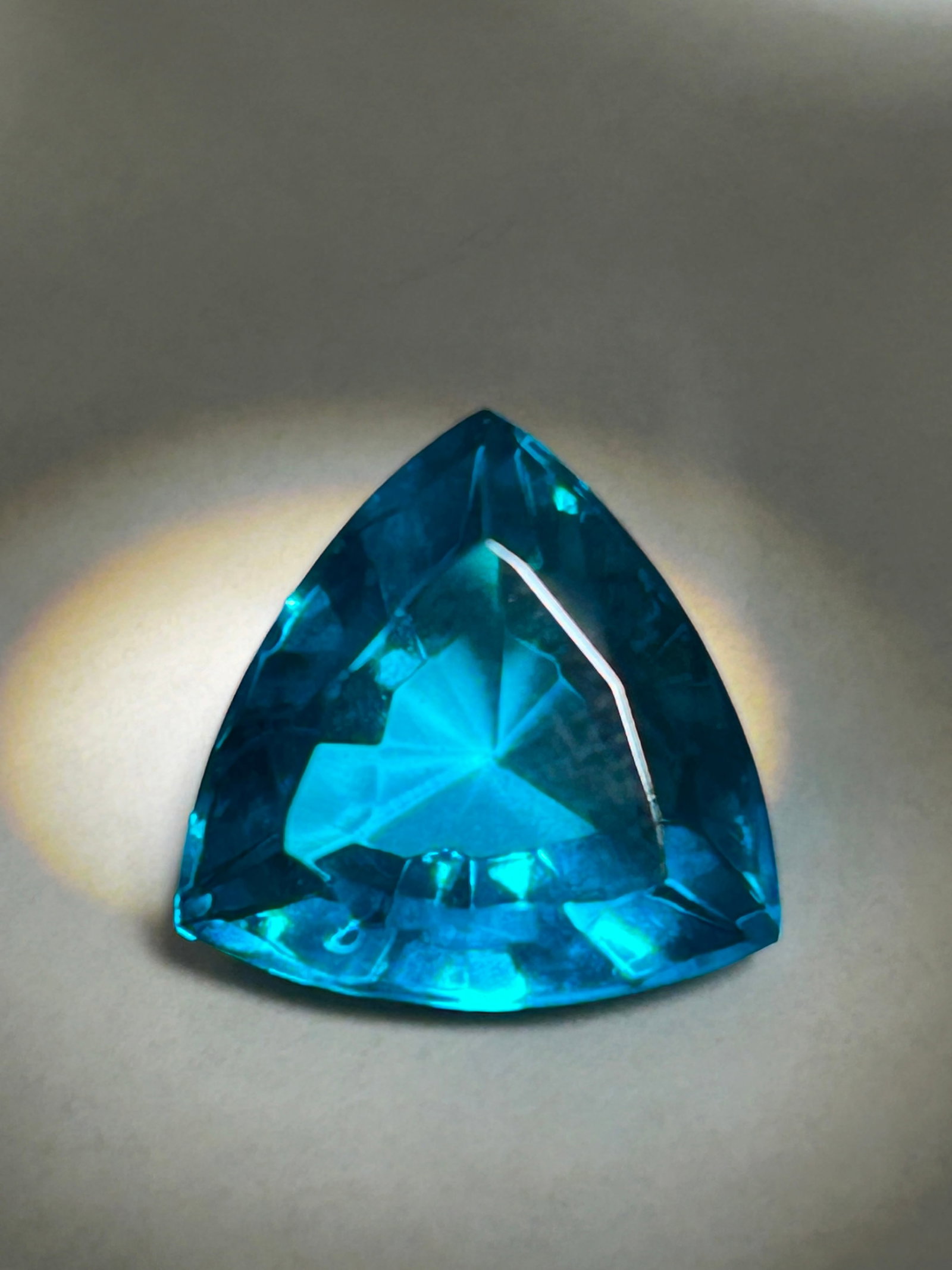 10 Carat Brazilian Teal Tourmaline Trillion Cut GGL Certified: Vibrant blue-green hues, sourced from Brazil and prized for its rarity and color. This stone features eye-clean clarity, a 7–7.5 hardness rating, and are typically used in statement jewelry due to t