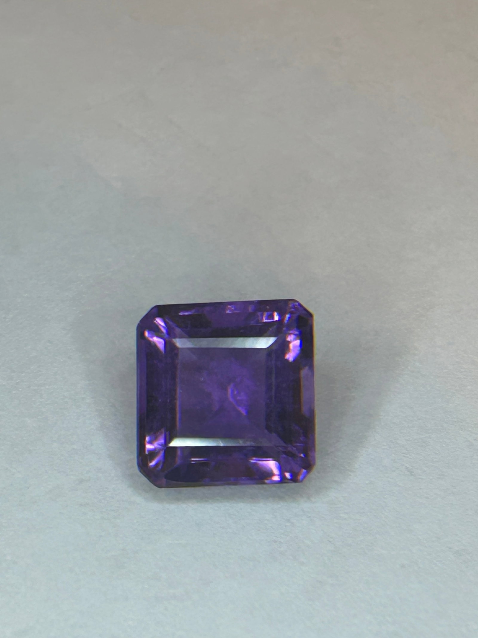 4.94 Carat Purple Amethyst Radiant Square Emerald Cut IGI Certified: A 4.94-carat purple amethyst with a square emerald cut (often described as a radiant square, radiant emerald, or square step-cut) is a significant-sized, high-quality colored gemstone often featuring 