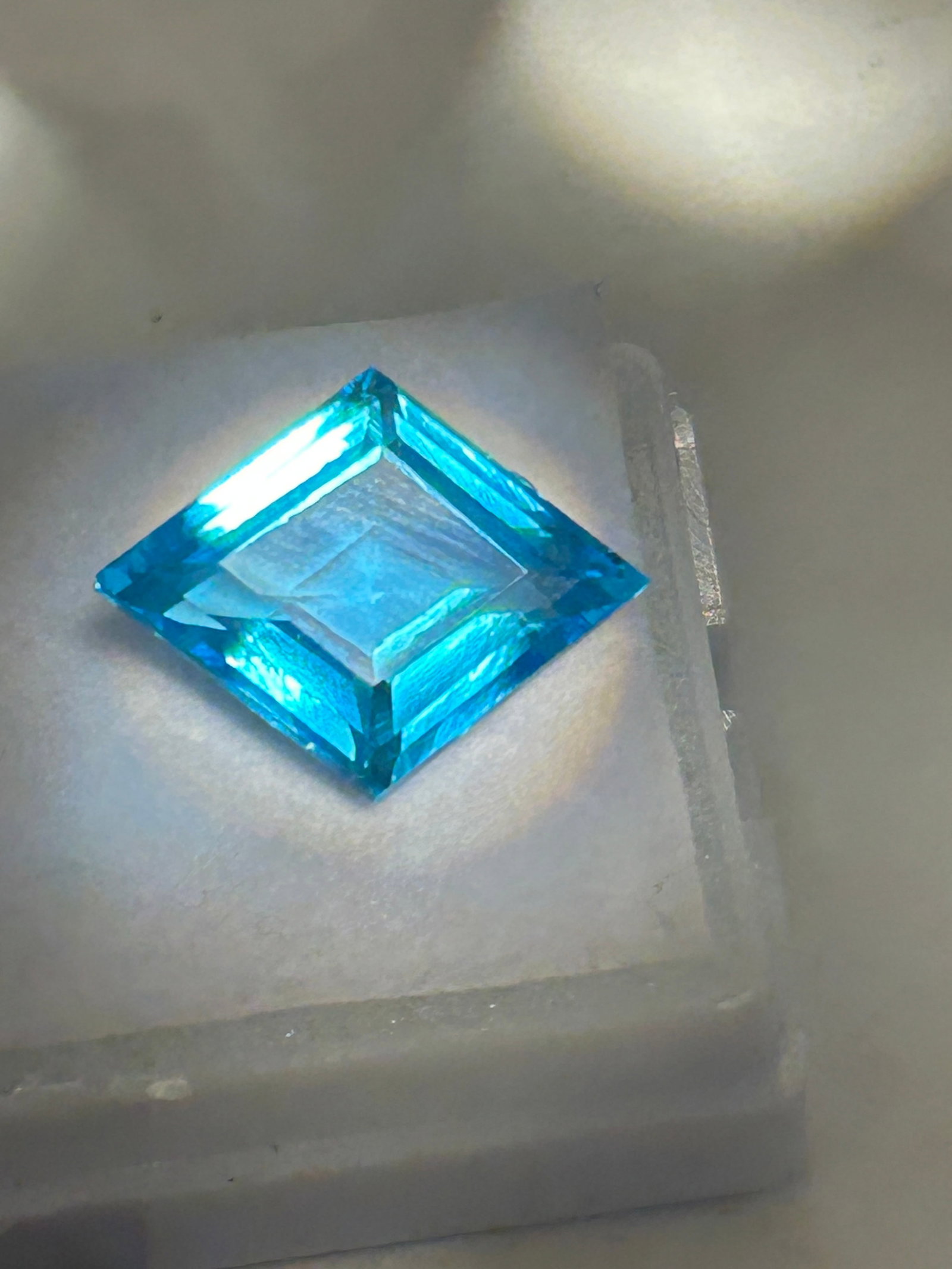 10 Carat Brazilian Neon Blue Tourmaline Fancy Cut GIE Certified: A fancy cut is an exceptionally rare, collector-grade gemstone characterized by an intense, electric cyan or neon blue hue, often with subtle green undertones. These stones possess high luminosity, so