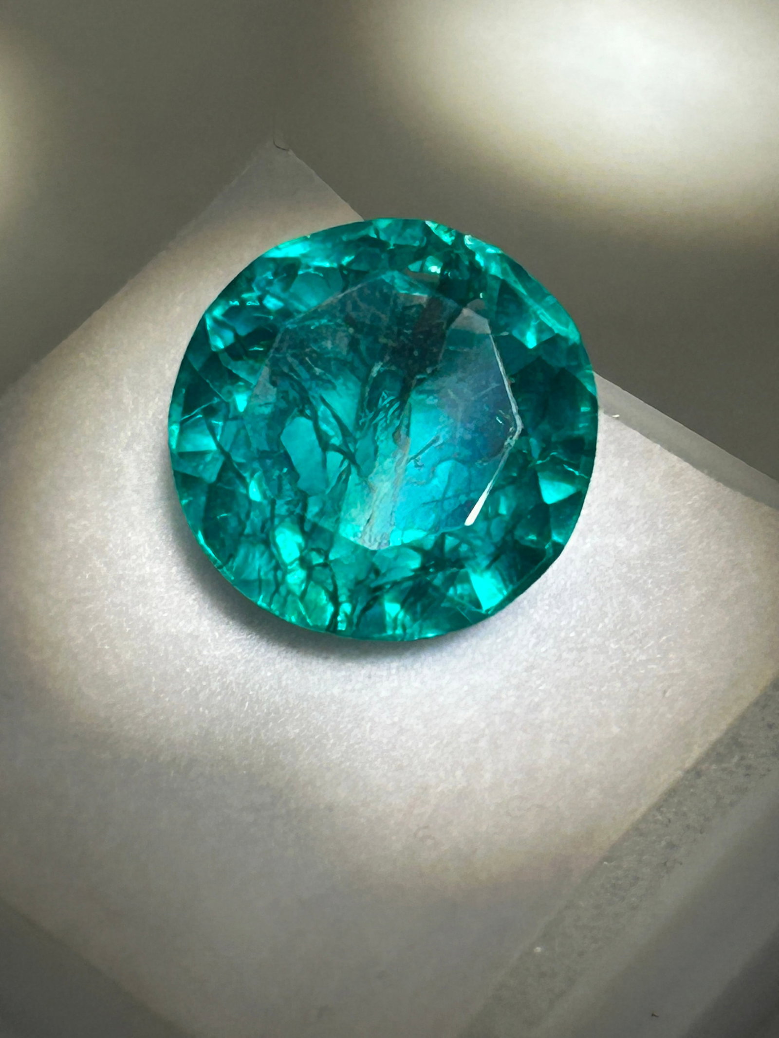 6.7 Carat Green Emerald Round Cut GGI Certified: Due to the difficulty of cutting rough emeralds into round shapes while maintaining weight, such a stone is likely to be a custom or specialized piece, often featuring rich green color, significant br