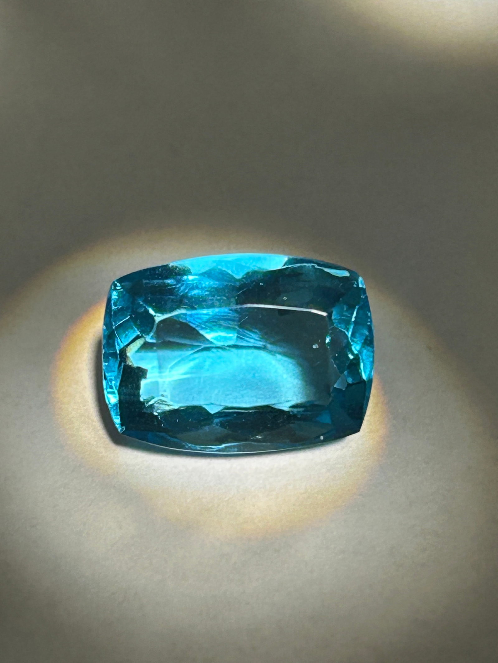 6.40 Carat Swiss Blue Topaz Cushion Cut GGL Certified Lab Grown: a significant, Loupe-clean gemstone typically used as a center stone for high-impact jewelry like cocktail rings or statement pendants.