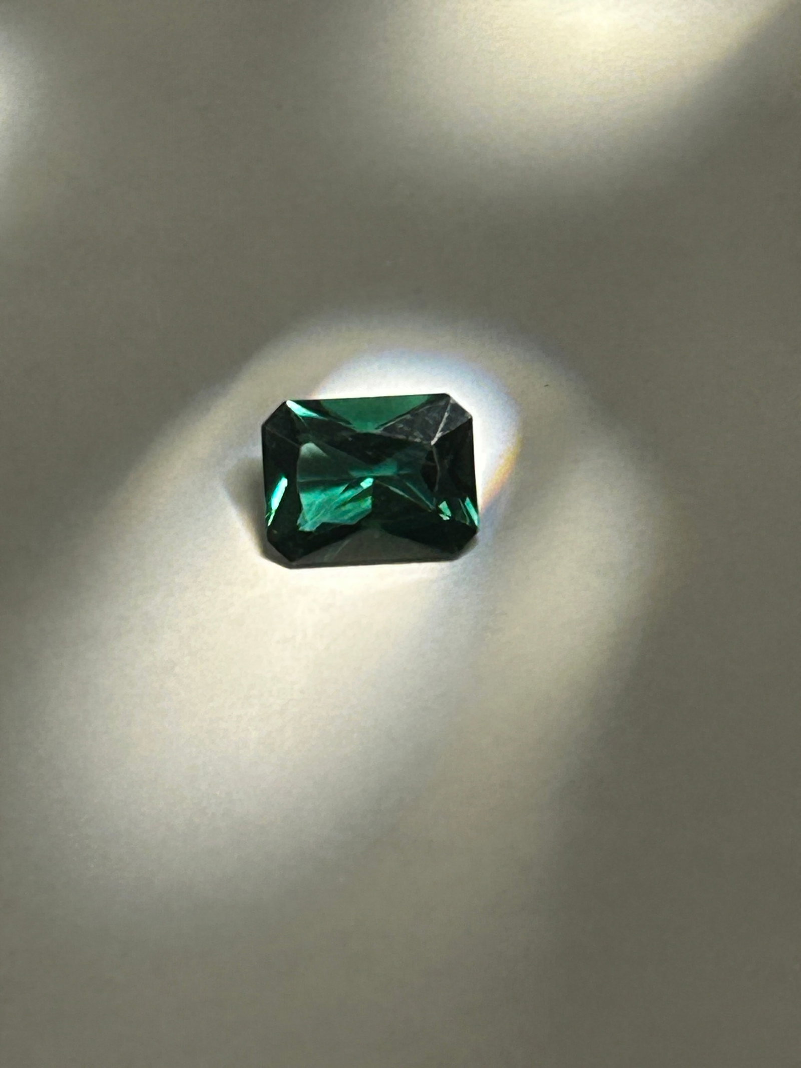 1.9 Carat ---- Dark Green Emerald ---- Emerald Step Cut: Emerald step cut is a striking, architectural gemstone. At this size, the elongated, rectangular shape with beveled corners emphasizes the gem’s rich color and "jardin" (natural inclusions) rather t
