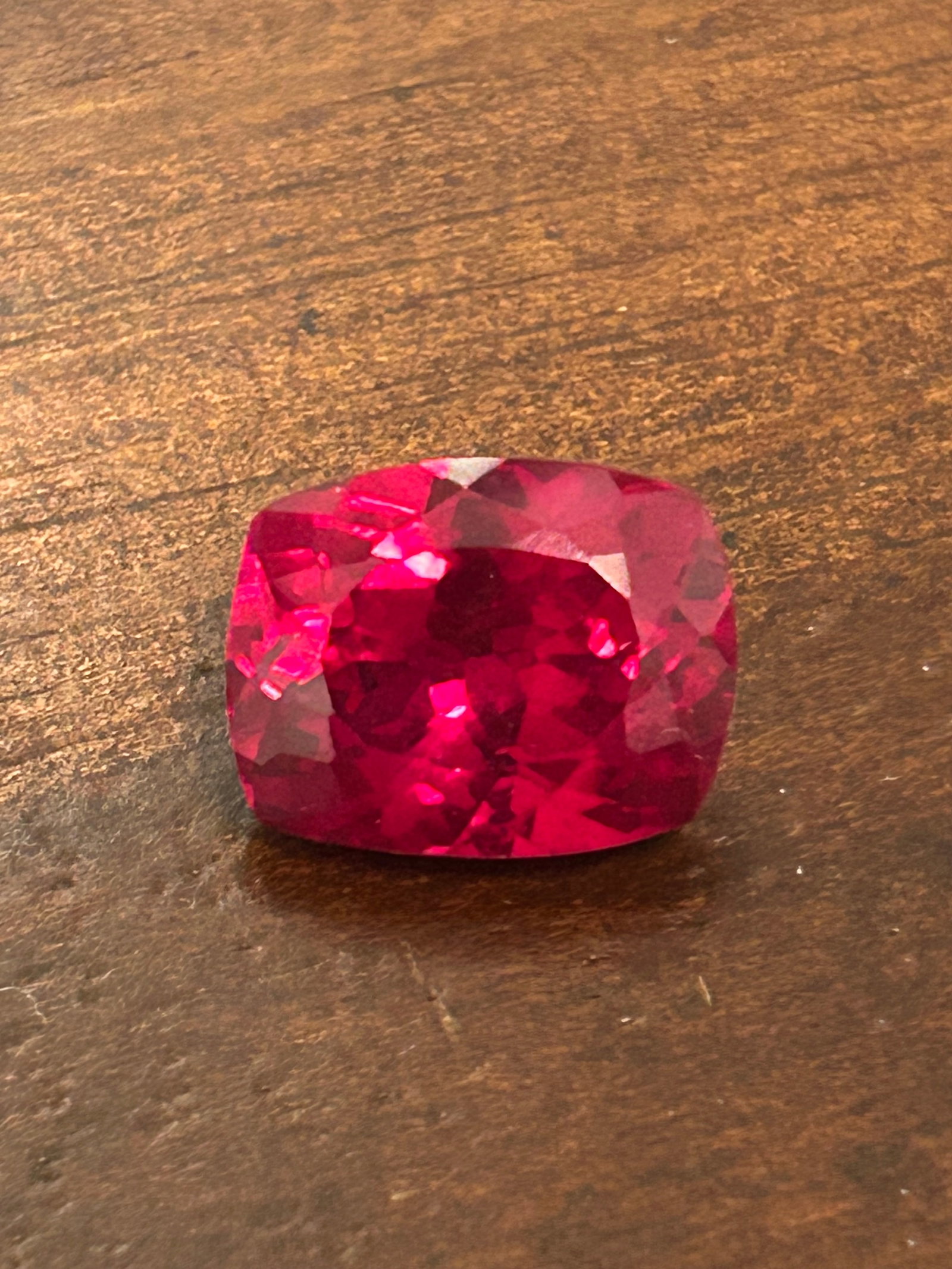 10.63 Carat ---- Ruby---- Mixed Cushion Cut ---- IGI Certified Lab Grown: lab-grown ruby with a mixed cushion cut is a substantial, luxurious gemstone produced in a laboratory setting using methods like hydrothermal or flame fusion (Czochralski process). This stone is chemi
