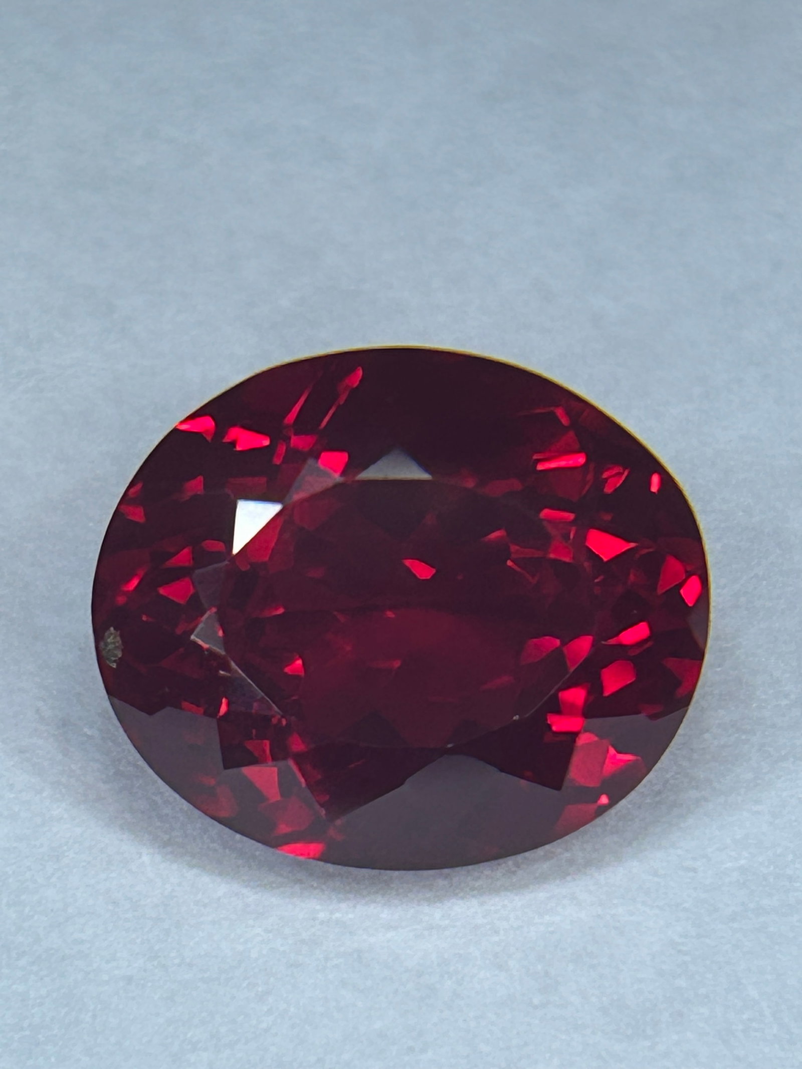 10.50 Carat ---- Red Ruby---- Oval Cut ---- GGI Certified: a significant, high-carat gemstone, often sourced from Mozambique or Burma, featuring a brilliant mixed cut to enhance color intensity. These stones typically possess intense red hues, often subjected