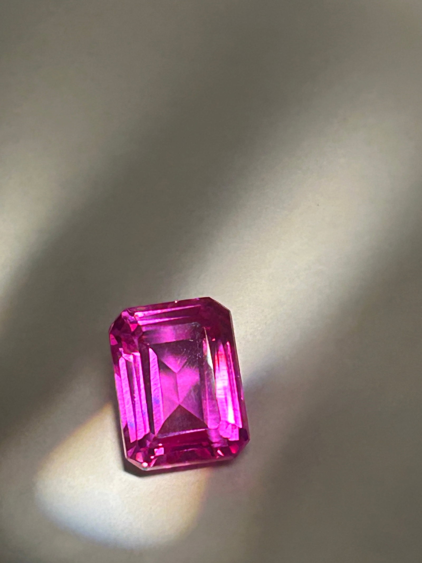 12.45 Carat ---- Burmese Pink Ruby---- Emerald Step Cut ---- EGL Certified: Burmese pink ruby with an emerald step cut is a significant and rare gemstone. At this weight, it is considered an exceptionally large specimen, as gem-quality Burmese rubies typically occur in much s