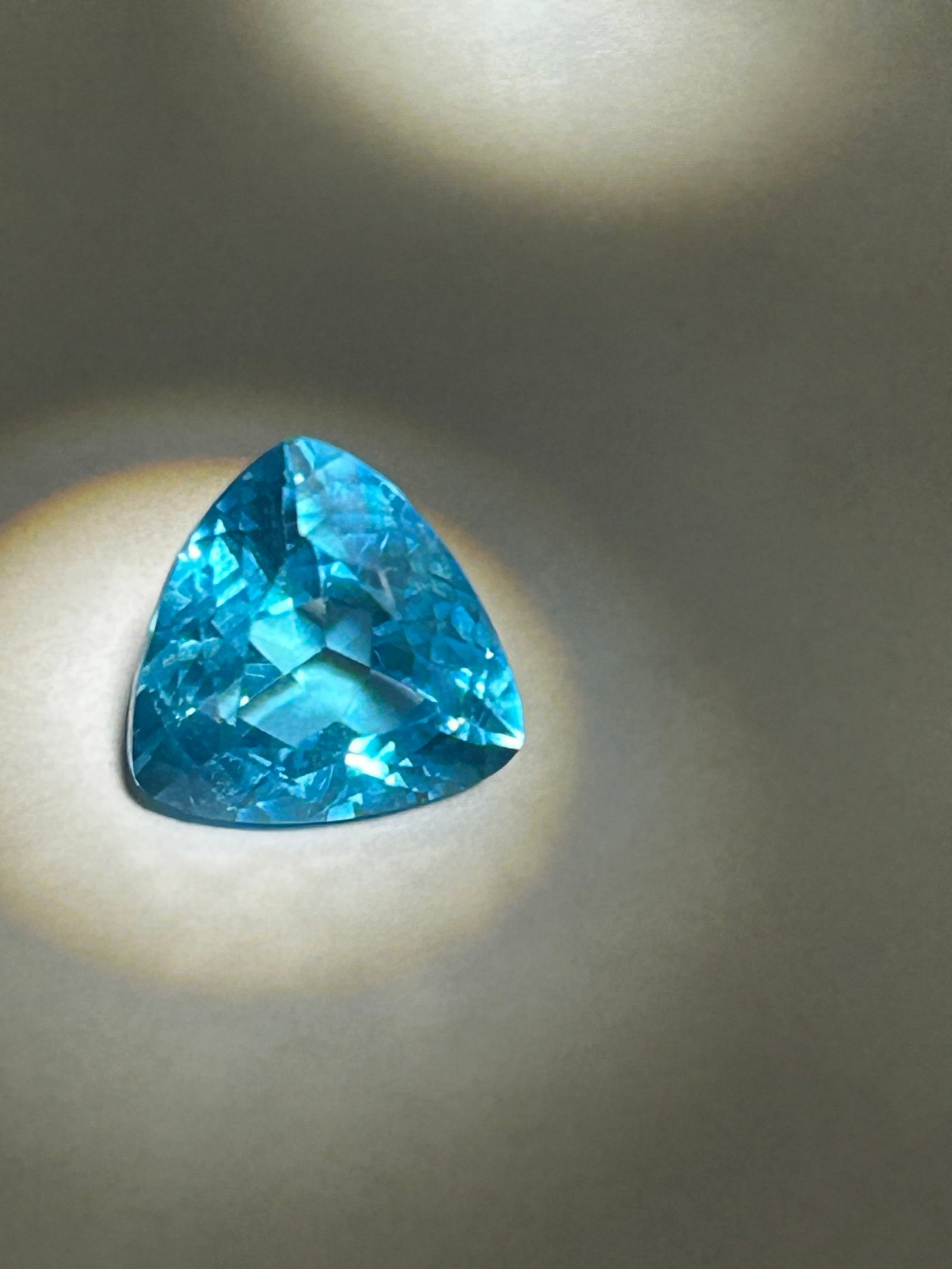 5.21 Carat --- Brazilian Neon Tourmaline --- Trillion Cut --- GIE Certified: This stone is defined by an electric, almost glowing "neon" blue or blue-green hue. The color is caused by trace amounts of copper and manganese within the crystal structure. High-quality specimens ar