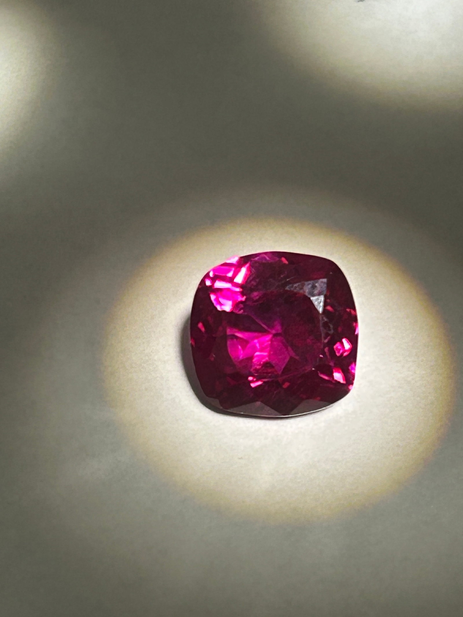 4.55 Carat --- Mozambique Raspberry Rhodolite Garnet --- Cushion Cut --- AGSL Certified: This 4.55-carat natural Mozambique Rhodolite Garnet is a vibrant, cushion-cut gemstone featuring a rich raspberry-red to pinkish-purple hue. Originating from Mozambique, this garnet type is known for 