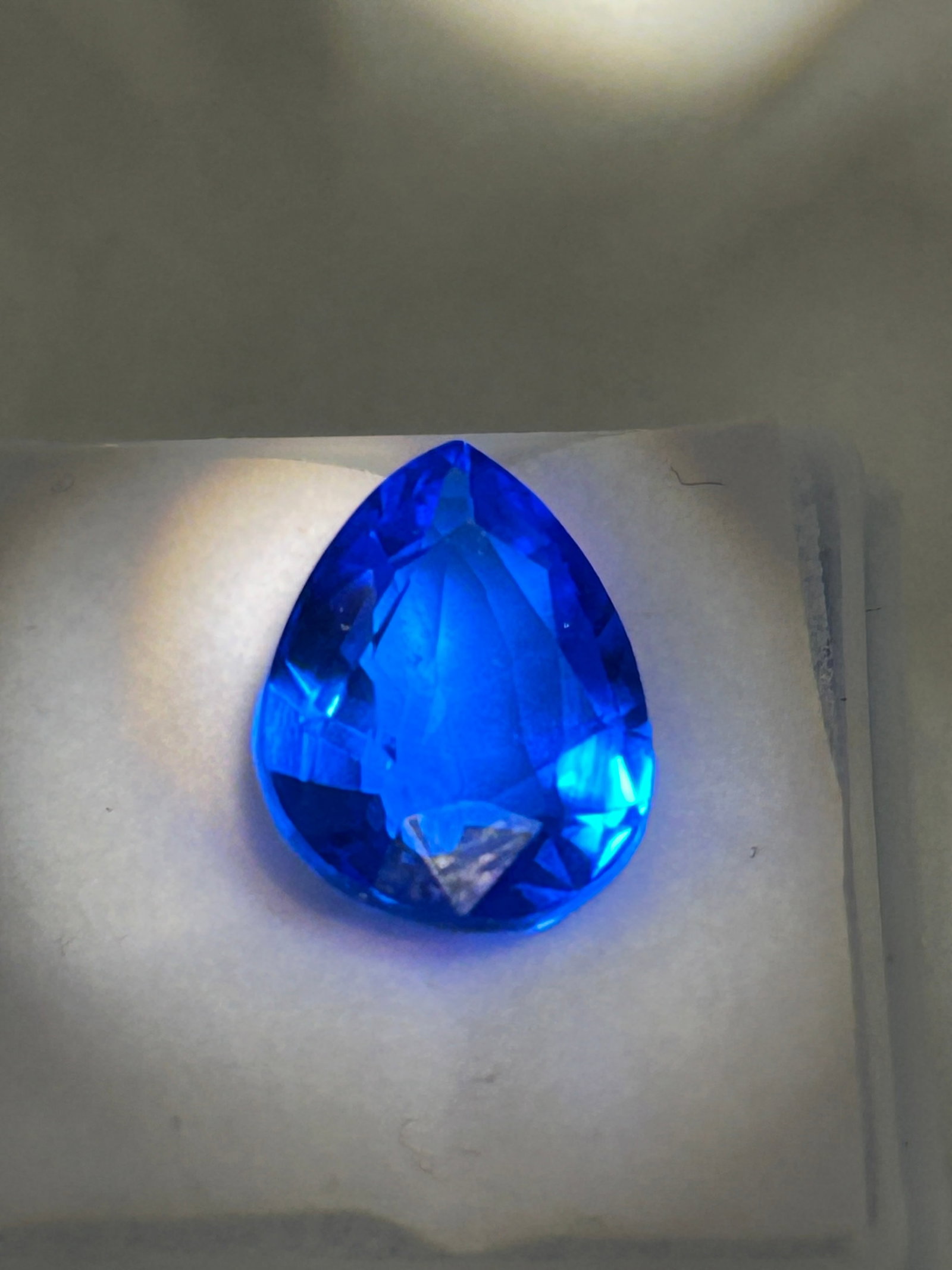 6.80 Carat--- Royal Blue Tazanite ---- Pear Cut----GGI Certified: A pear-cut gemstone, displaying a rich, deep "Royal Blue" hue with violet undertones, originating from Tanzania. Featuring high-grade clarity, this substantial, vibrant blue-violet pear-cut gem is com
