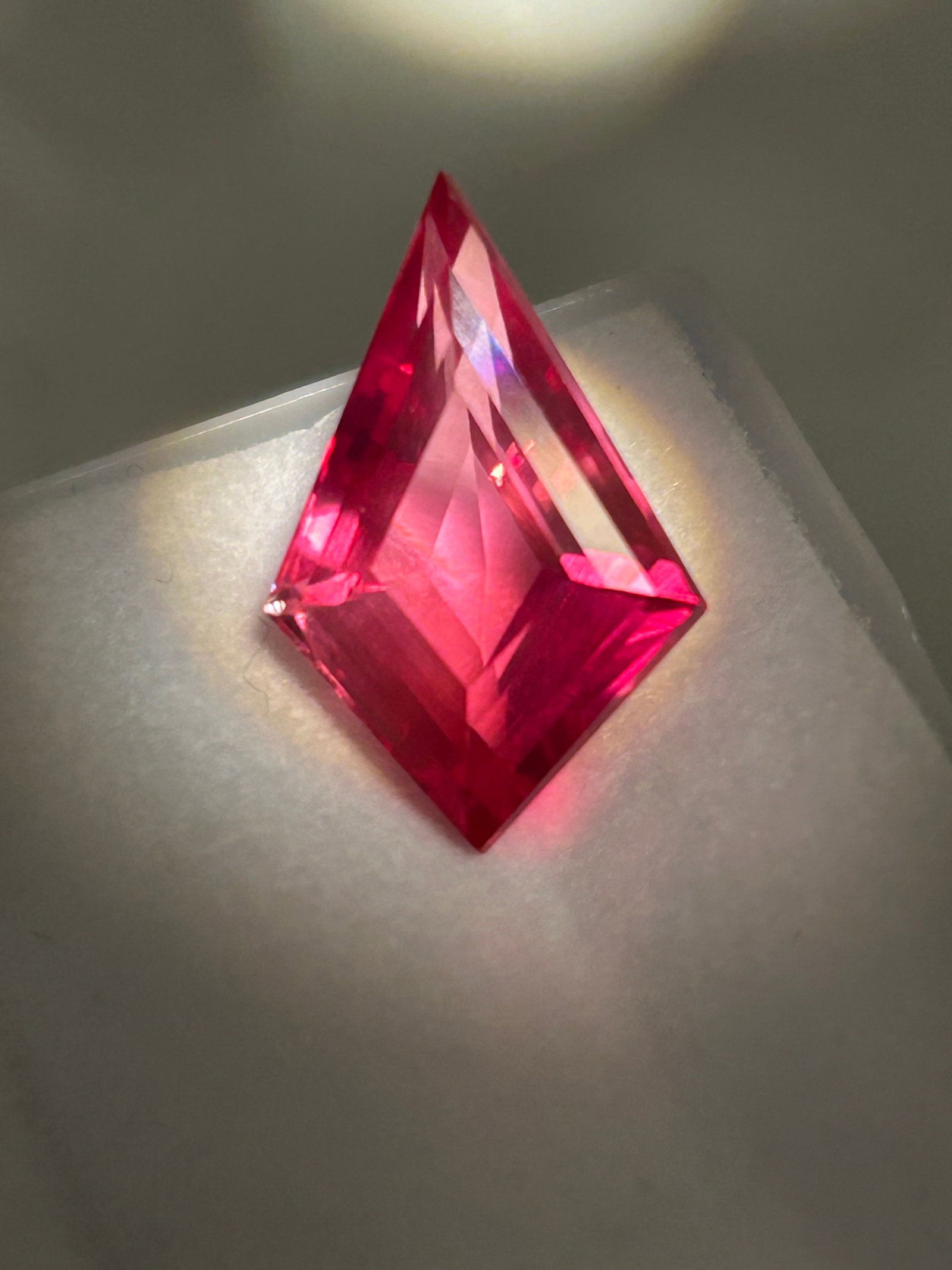 10.0 Carat --- Padparadscha Sapphire --- Fancy Kite Cut --- EGL Certified: An exceedingly rare and visually striking gemstone. It features an iconic, delicate blend of pink and orange hues reminiscent of a sunset, tailored into an angular, modern geometric shape