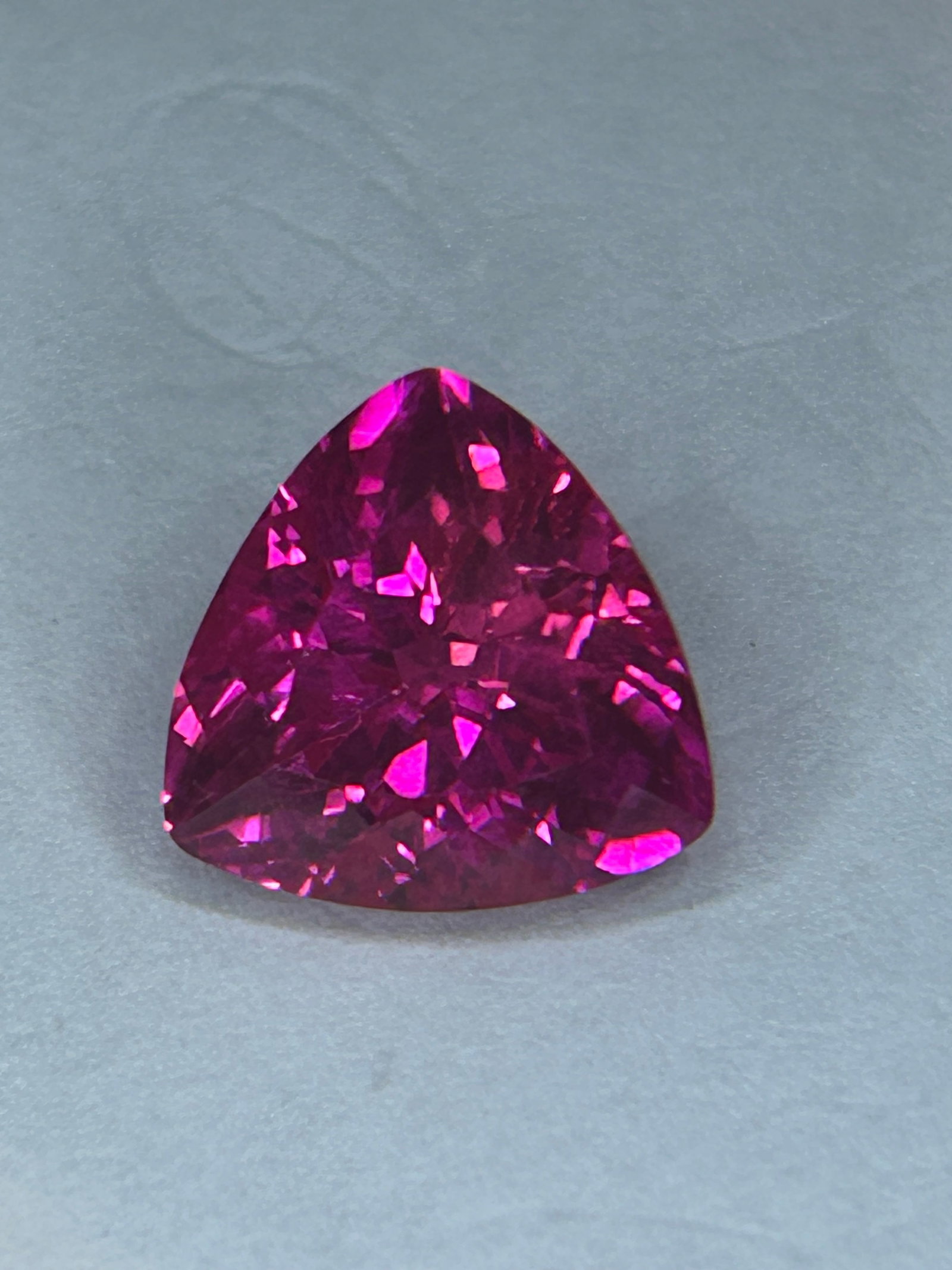 8.00 Carat --- Tanzanian Hot Pink Spinel --- Trillion Cut --- GGI Certified: A substantial and vibrant gemstone. Sourced from Tanzania. Chosen for its high durability and consistent, vivid color. The vivid hot pink sits at the highest end of the valuation scale. Neon pink spin