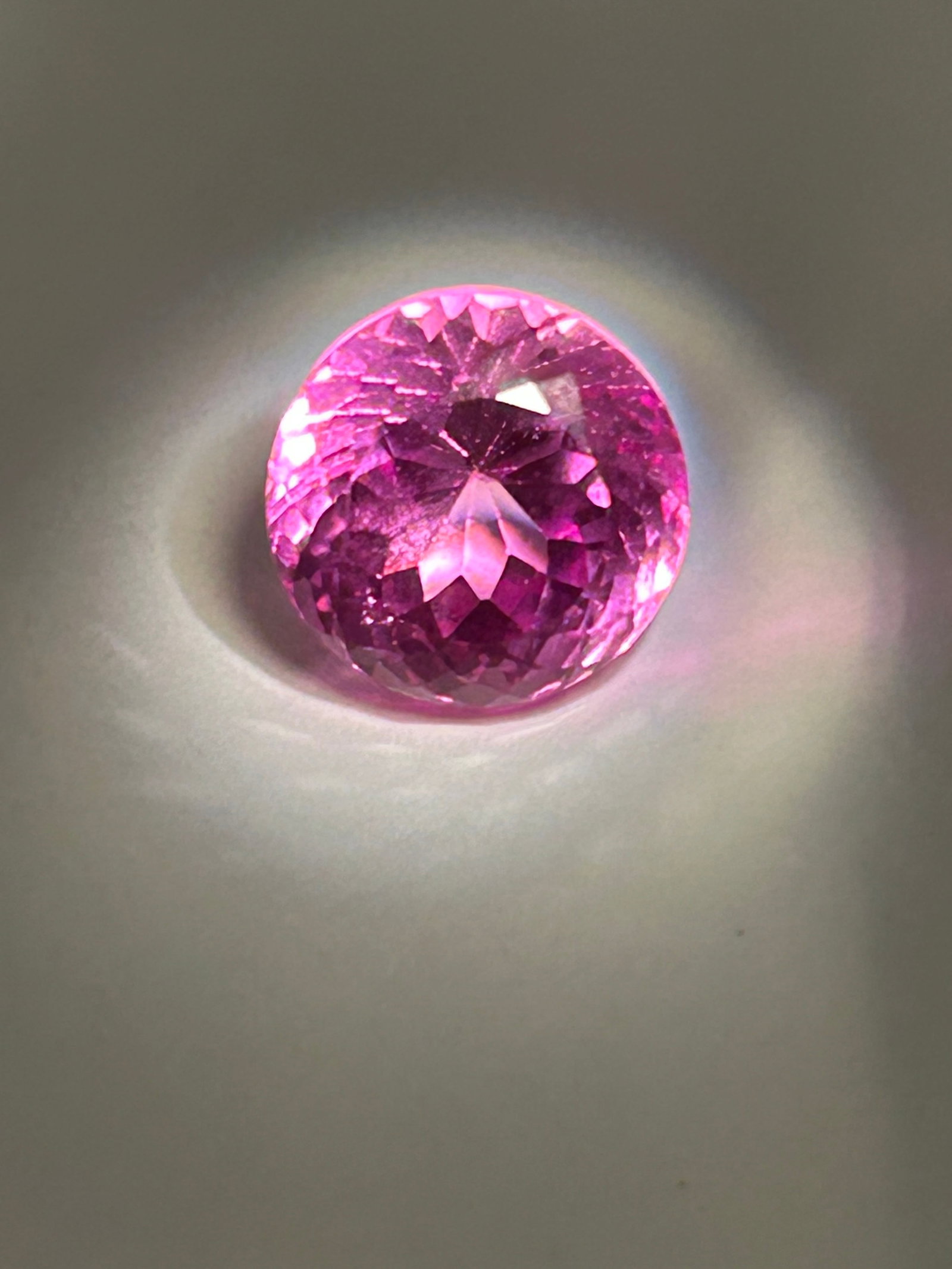 11.70 Carat --- Ceylon Pink Sapphire--- Round Cut --- GGI Certified: Hailing from Sri Lanka, it is prized for its soft, brilliant, and highly luminous color. Because natural sapphires of this size are rare, such a stone commands significant value in fine jewelry.