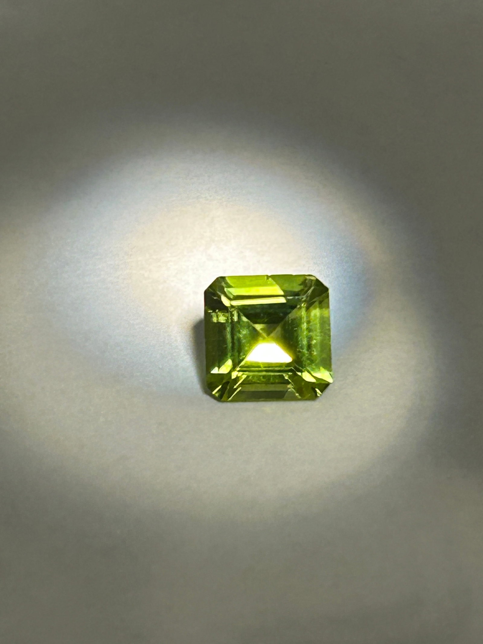 1.40 Carats ---- Natural Peridot Square ----Emerald Asscher Cut: A vibrant, mid-sized gemstone known for its distinctive "step-cut" faceting and "volcanic" lime-to-olive green hue. This specific cut, also referred to as a square emerald or Asscher cut, emphasizes t